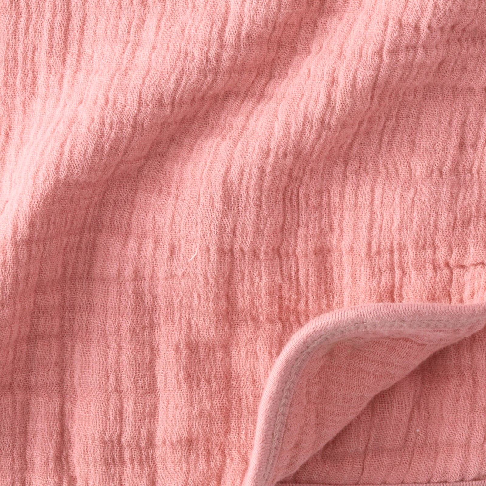 Close-up of soft pink fabric with a subtle texture