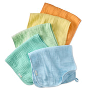 Set of five colorful baby burp cloths on a white background
