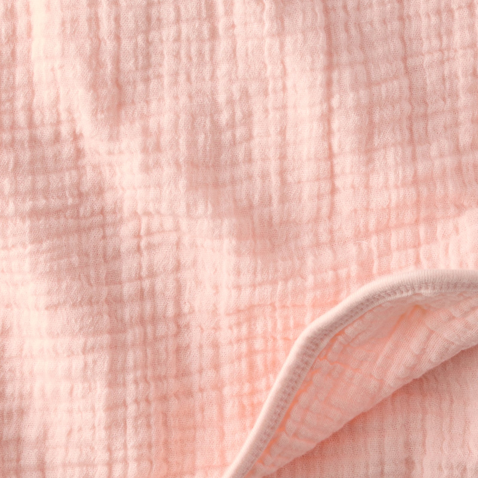Close-up of pink textured fabric with a white border