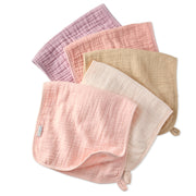 Set of five soft, textured baby burp cloths in various colors on a white background