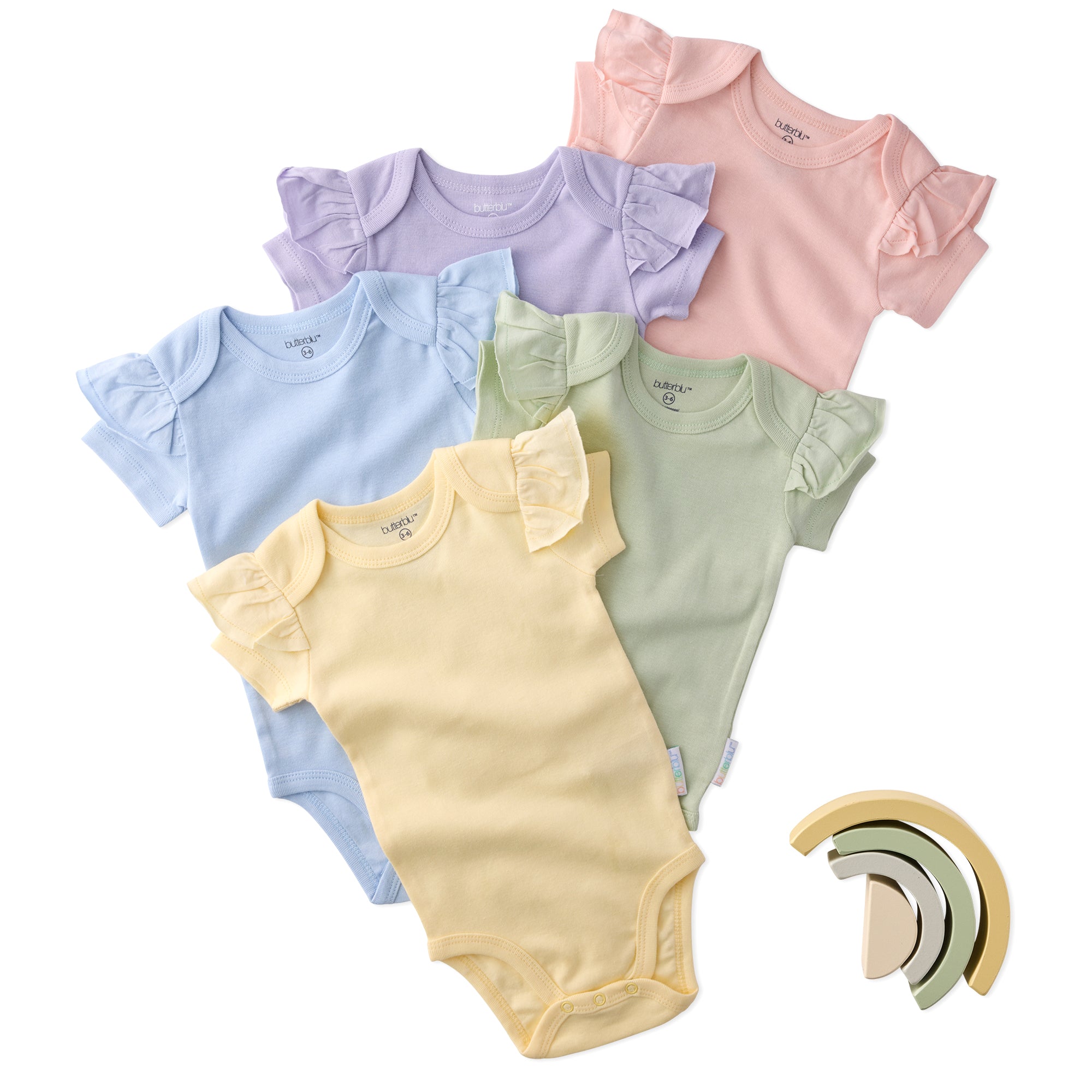 Set of colorful baby bodysuits with a rainbow-shaped teether on a white background