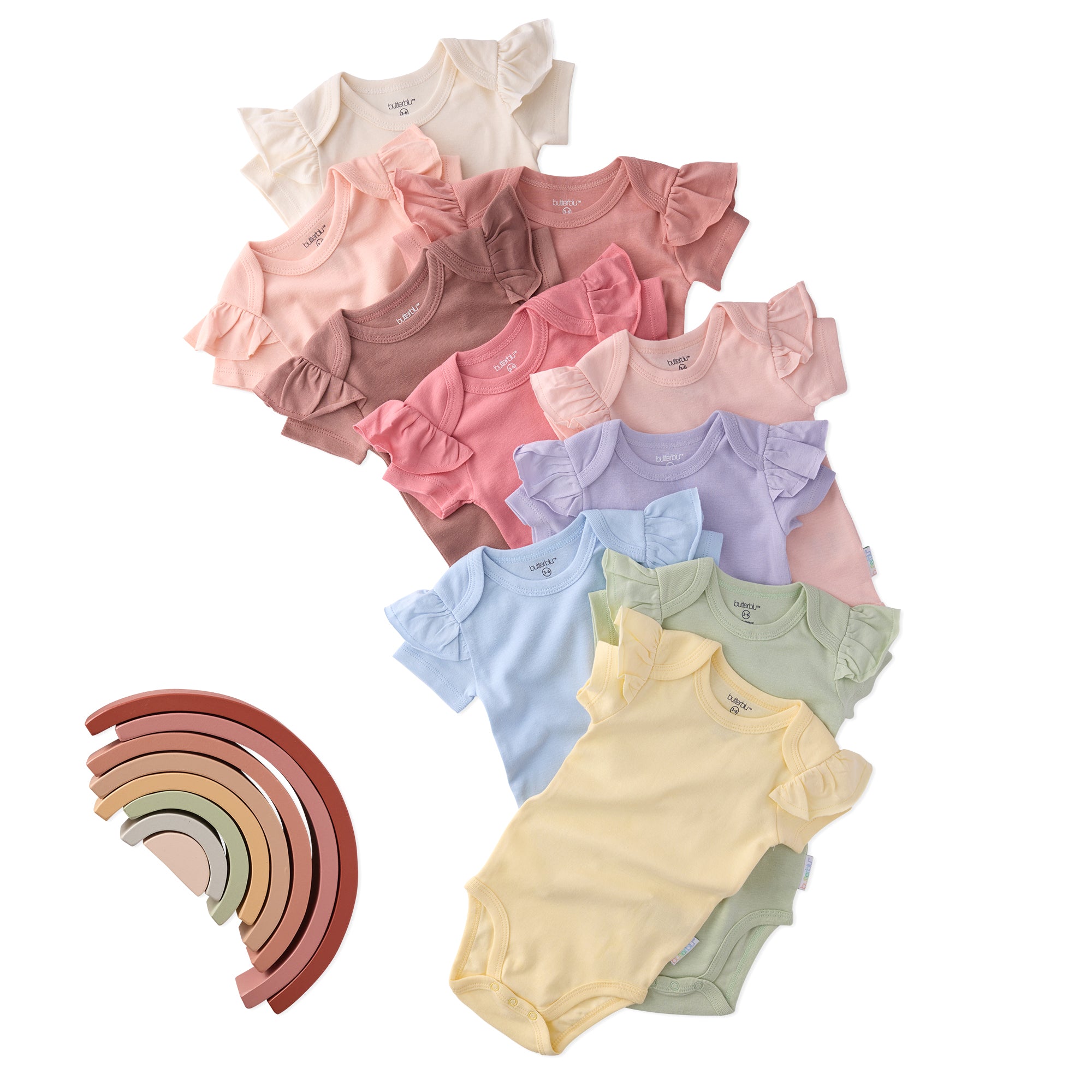 Stack of colorful baby bodysuits with a wooden rainbow toy on a white background