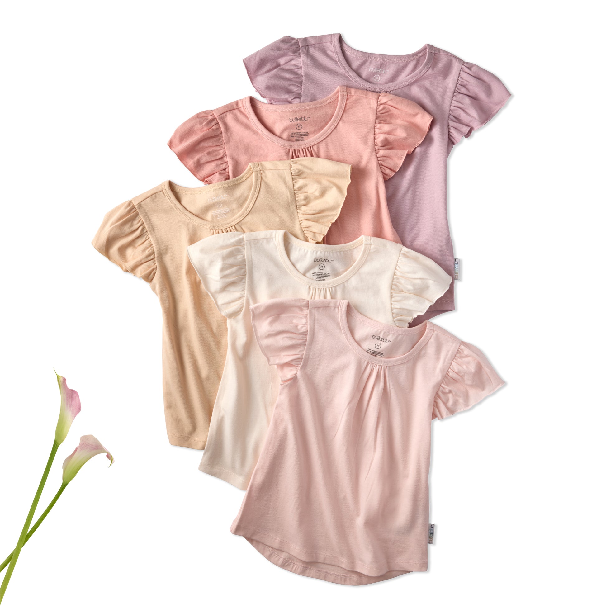 Set of four baby girl shirts in pink, beige, and white with ruffled sleeves on a white background.