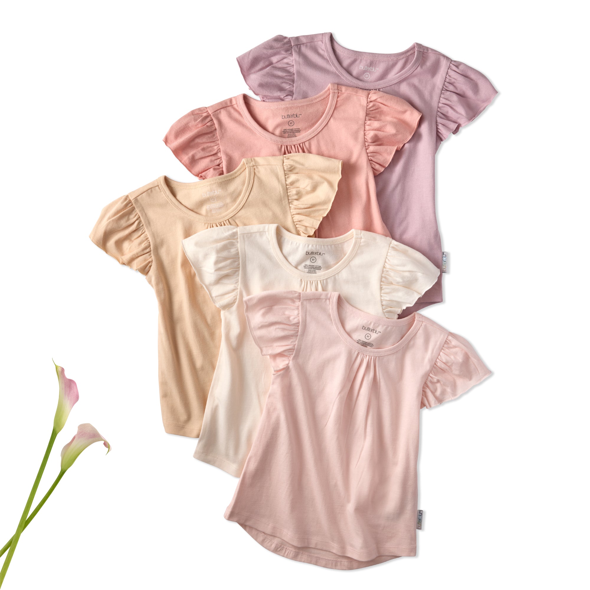 Set of four baby girl shirts in pink, beige, and white with ruffled sleeves on a white background.