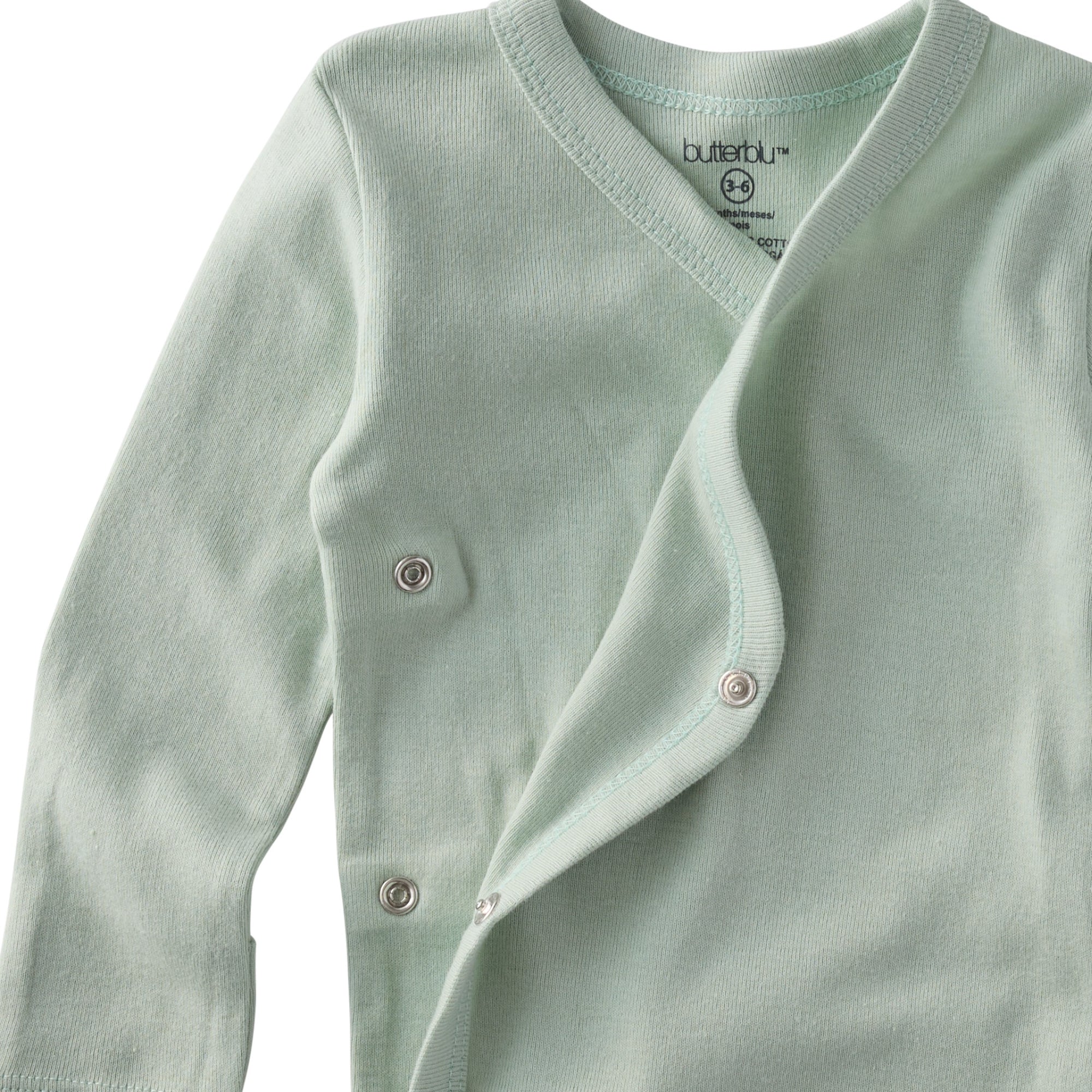 Light green baby cardigan with buttons on a white background