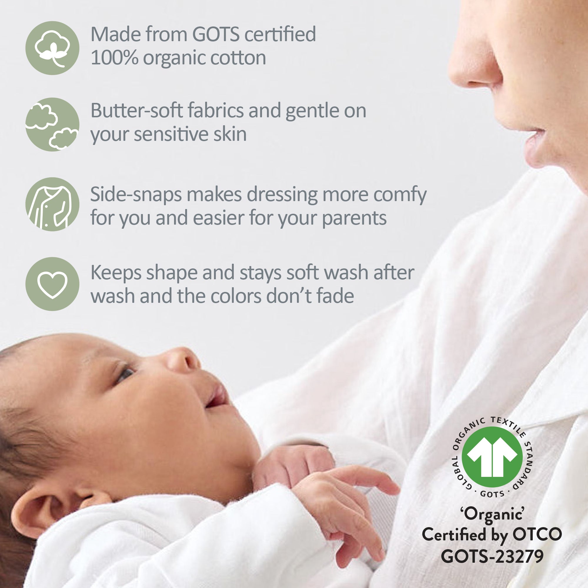 Baby wrapped in organic cotton fabric with GOTS certification label.