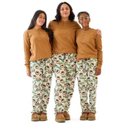 Three women wearing matching brown tops and patterned pants on a white background