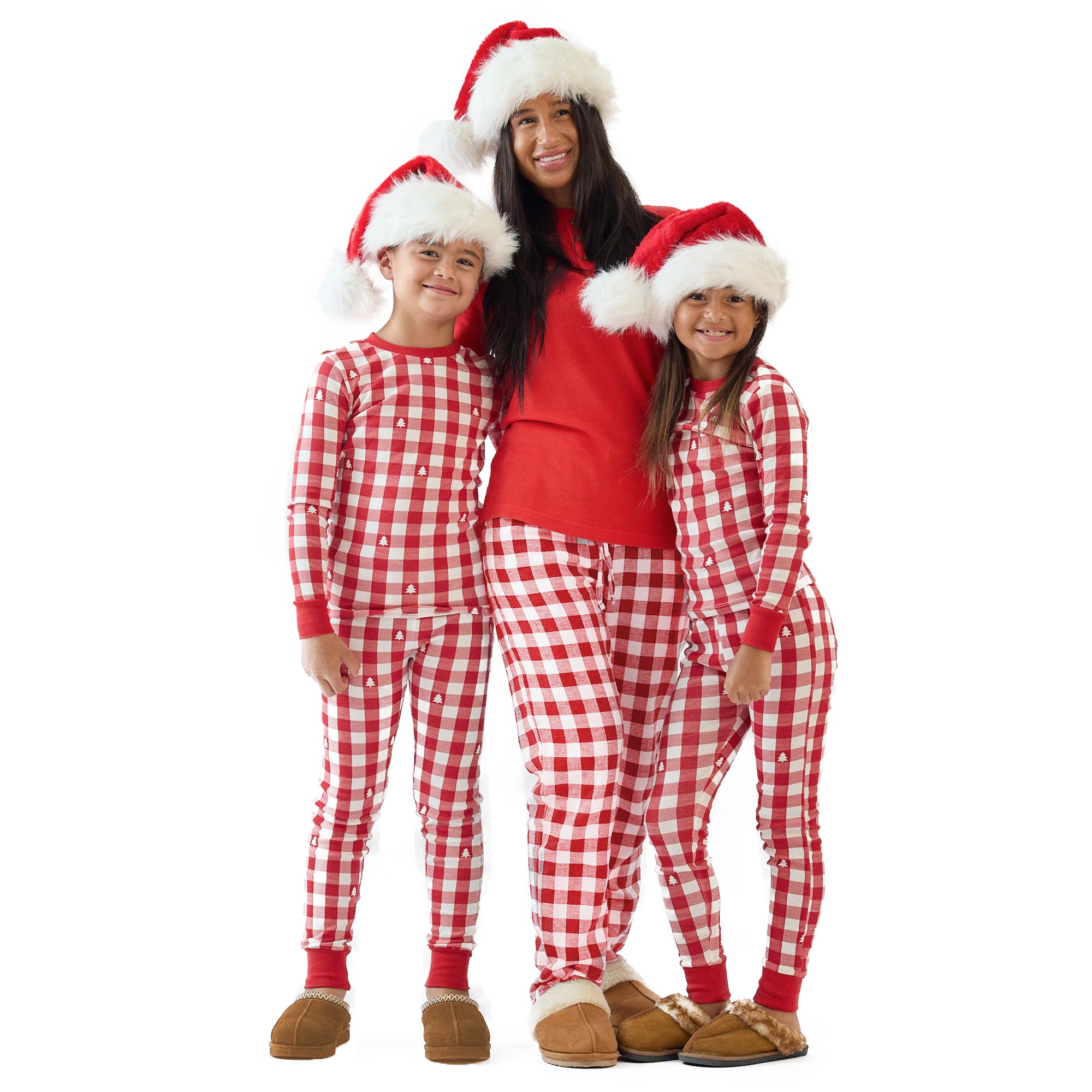 A family wearing red and white checkered pajamas with Santa hats on a white background