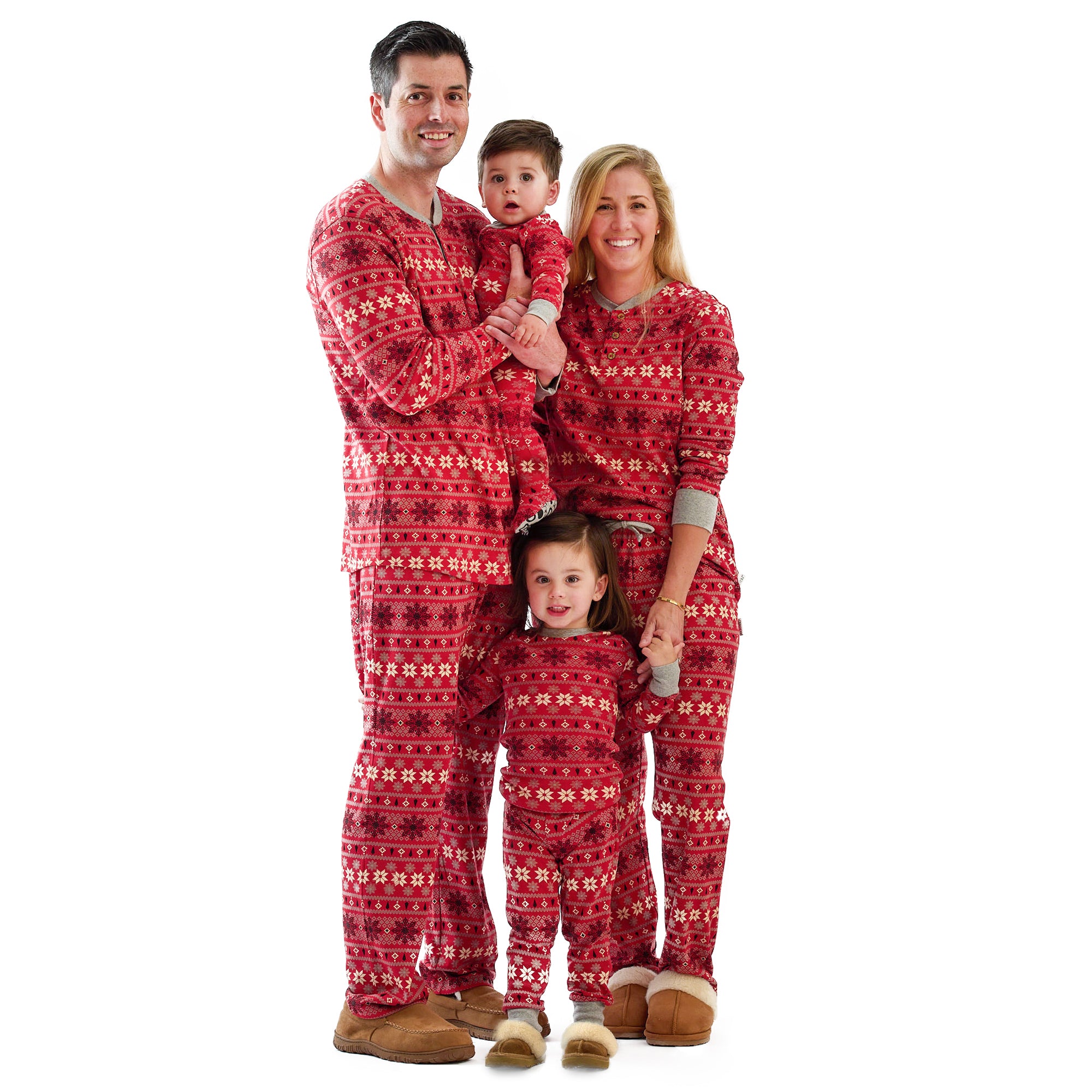 Family of four wearing matching red pajamas with a white background
