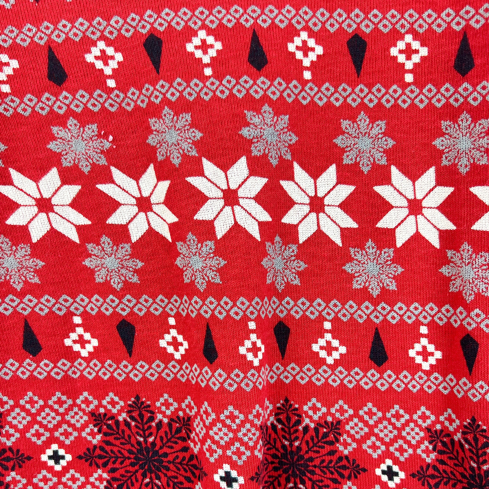 Red fabric with white, black, and gray snowflake pattern