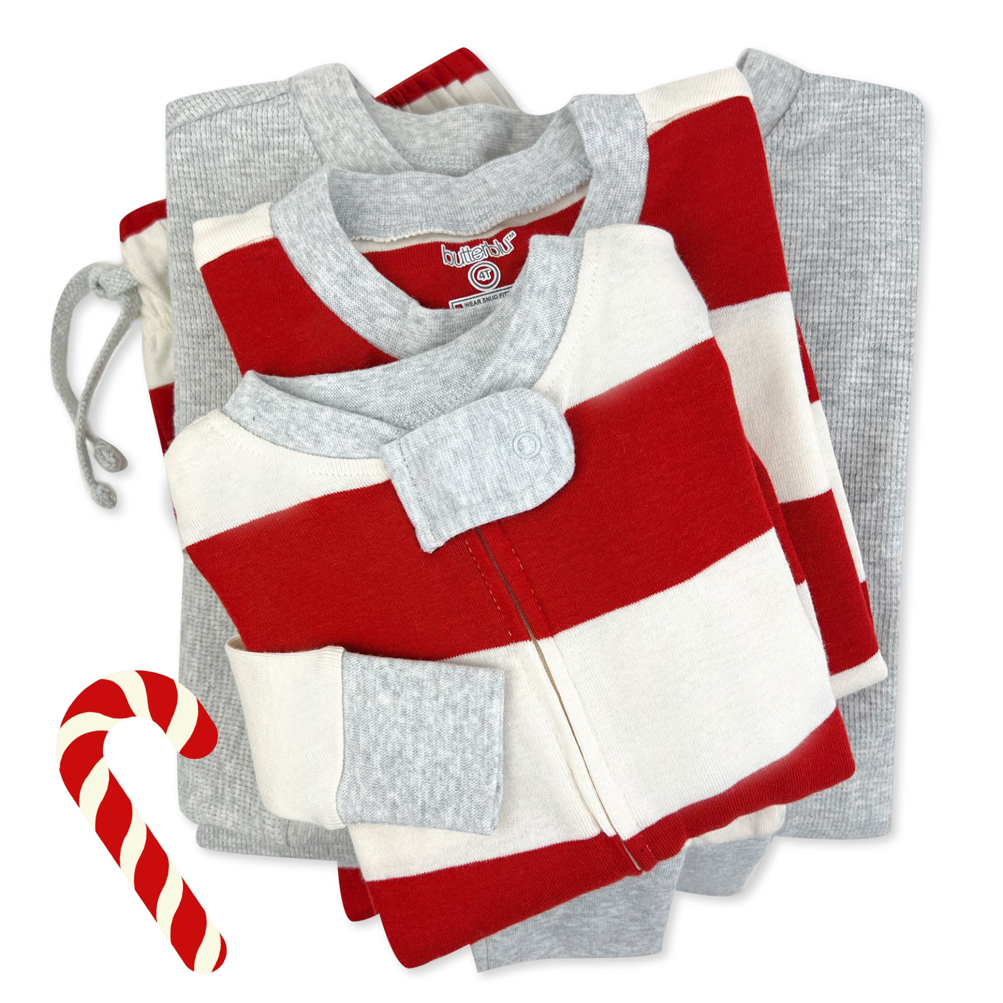 Stack of folded matching family pajamas with a candy cane on a white background