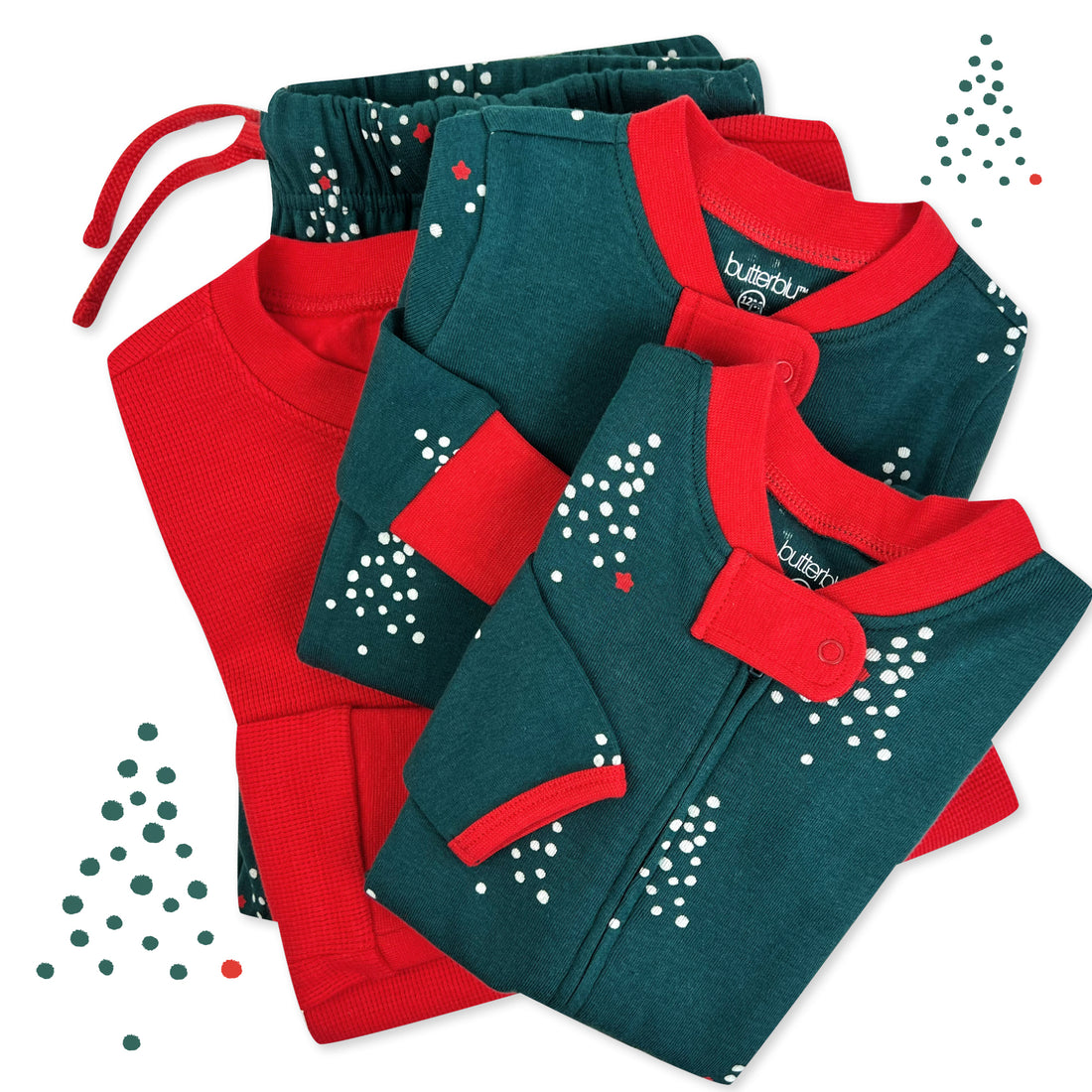 Folded red and green baby rompers with white patterns on a white background