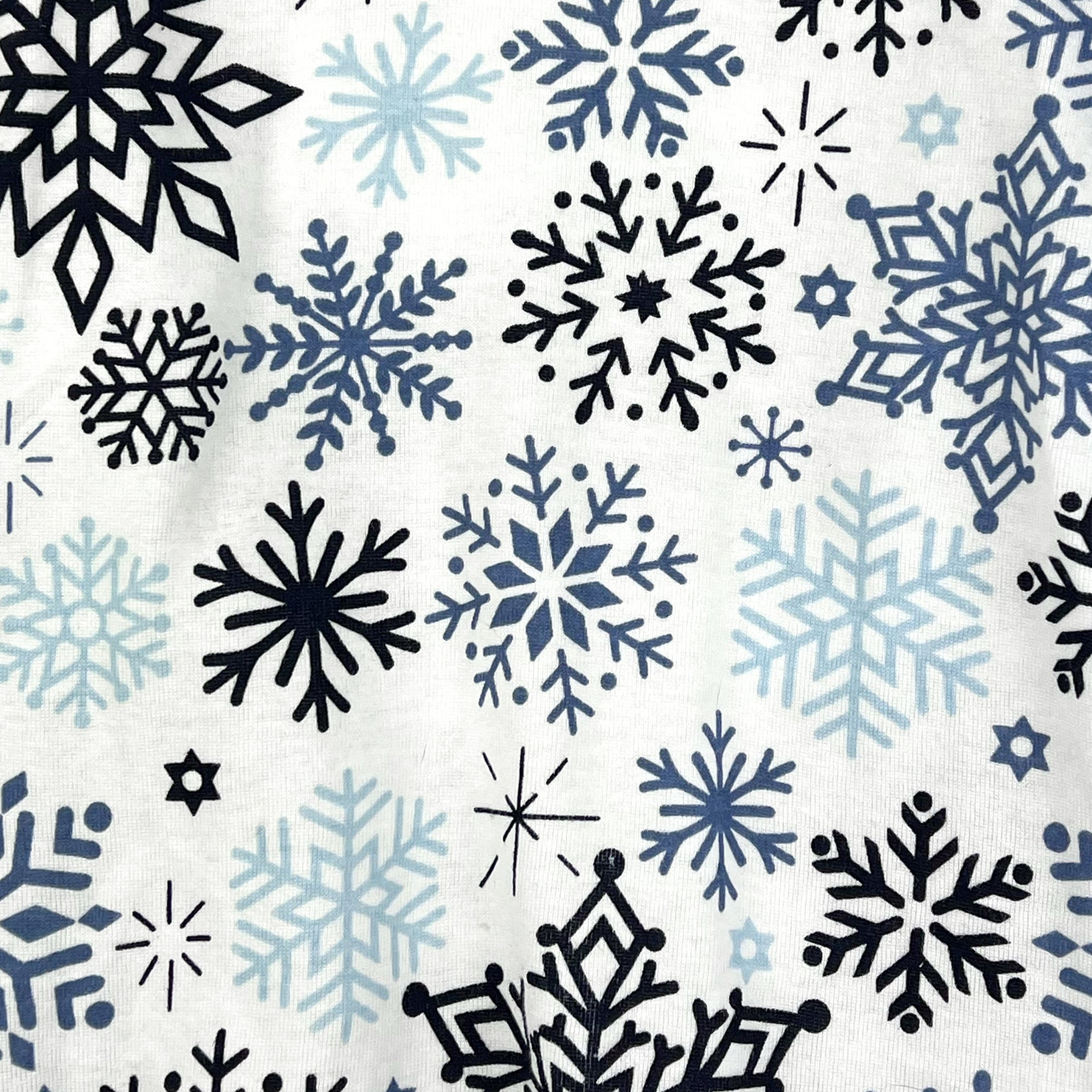 Pattern of black and blue snowflakes on a white background