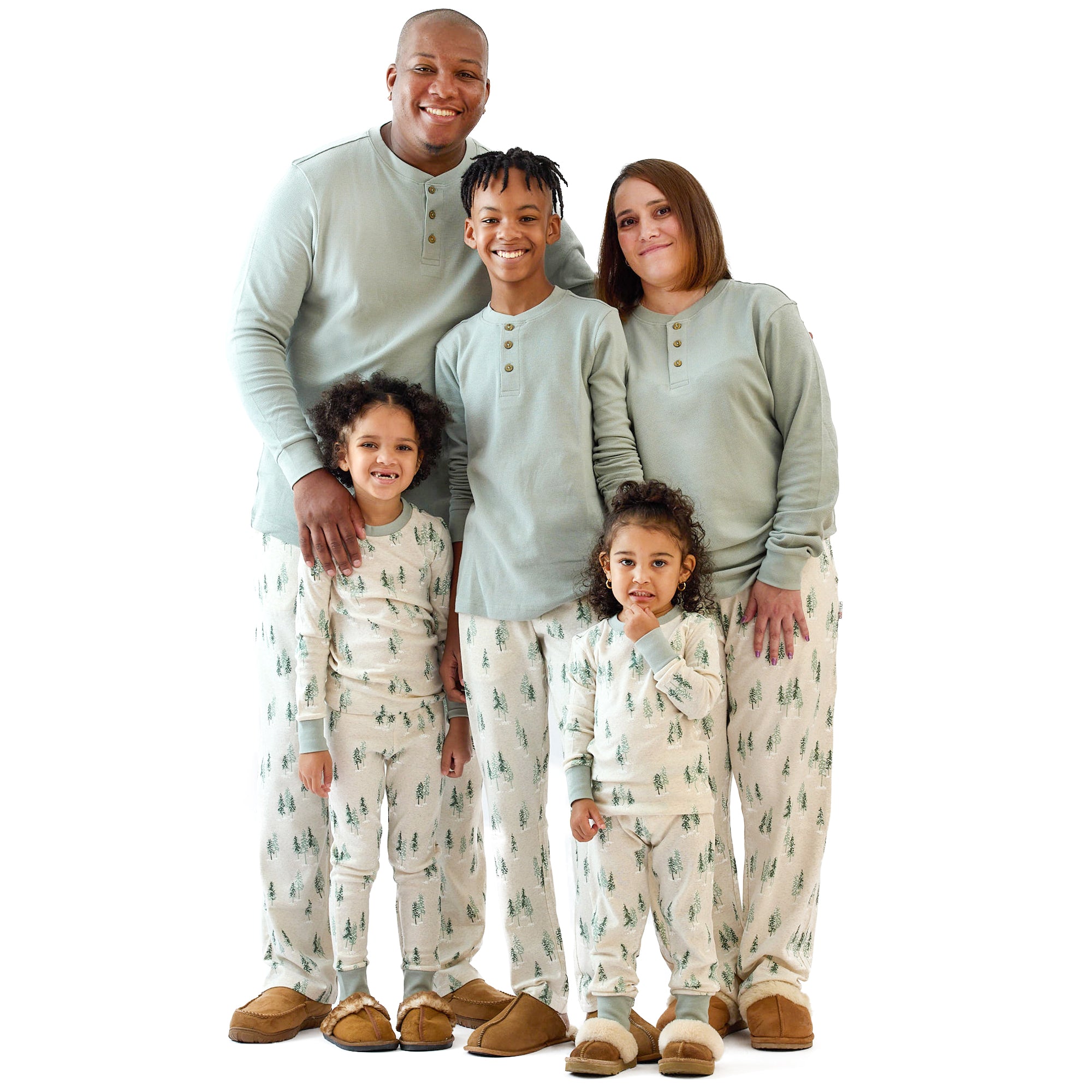 Family of five wearing matching pajamas on a white background