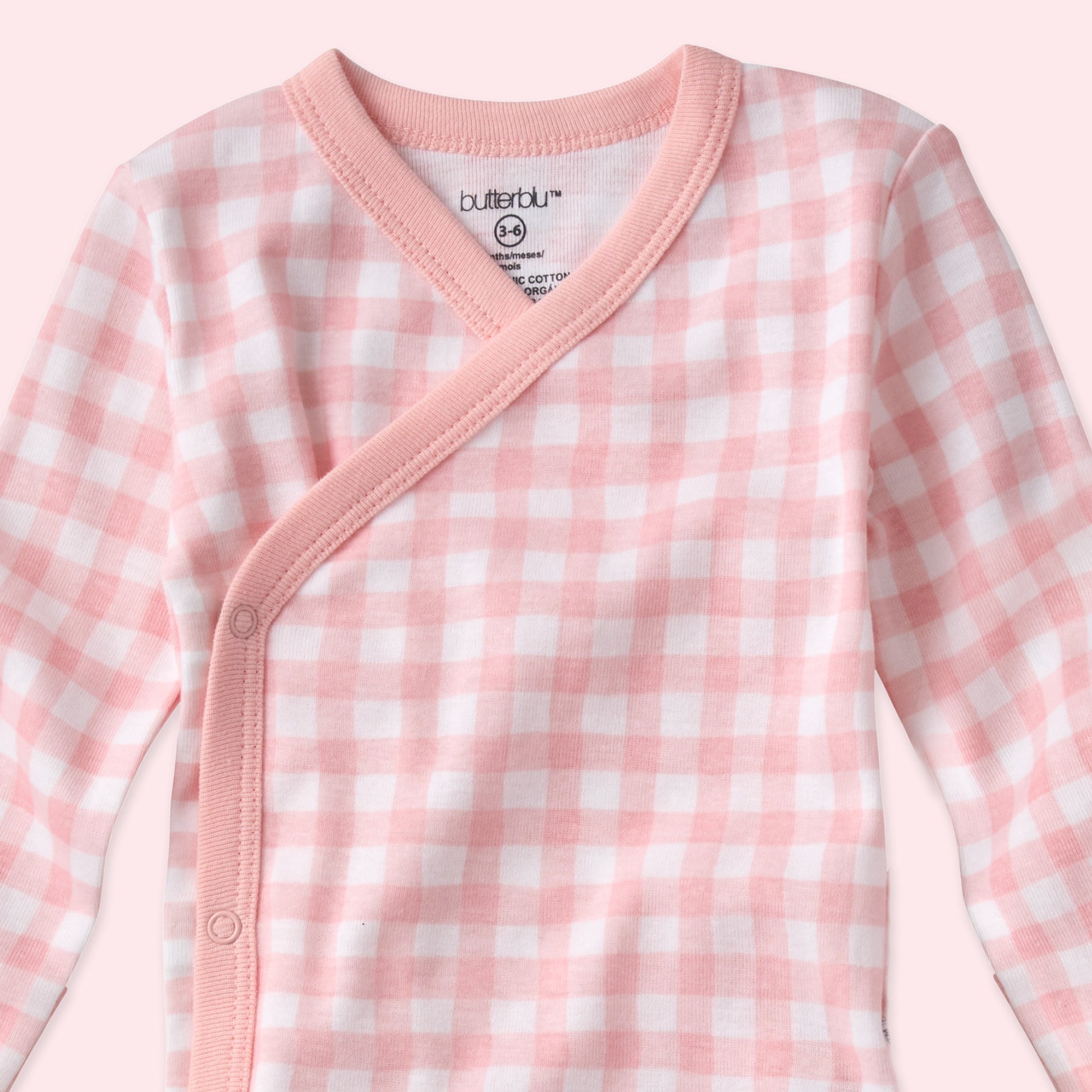 Pink and white checkered baby outfit with 'butterblu' branding on a white background