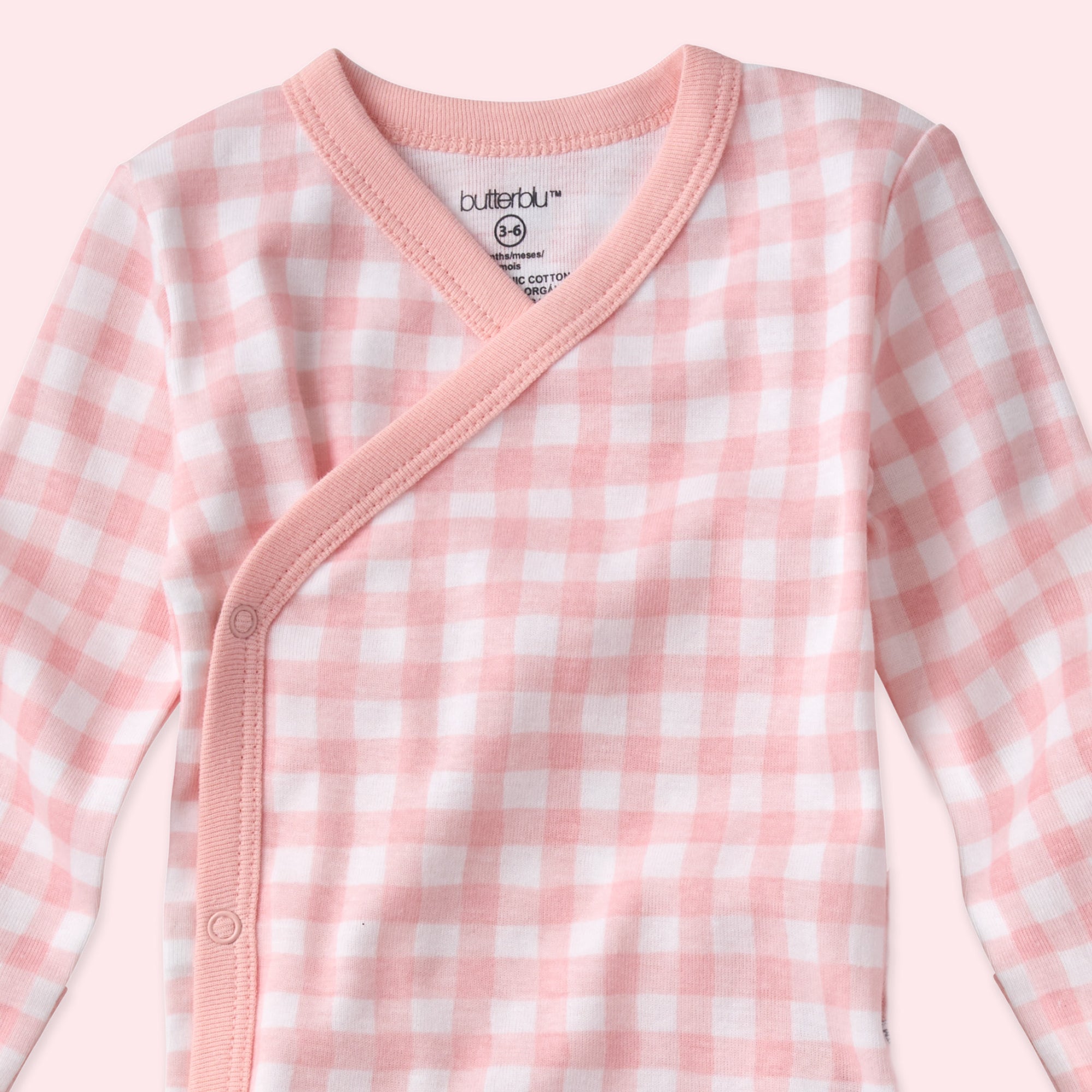 Pink and white checkered baby outfit with 'butterblu' branding on a white background