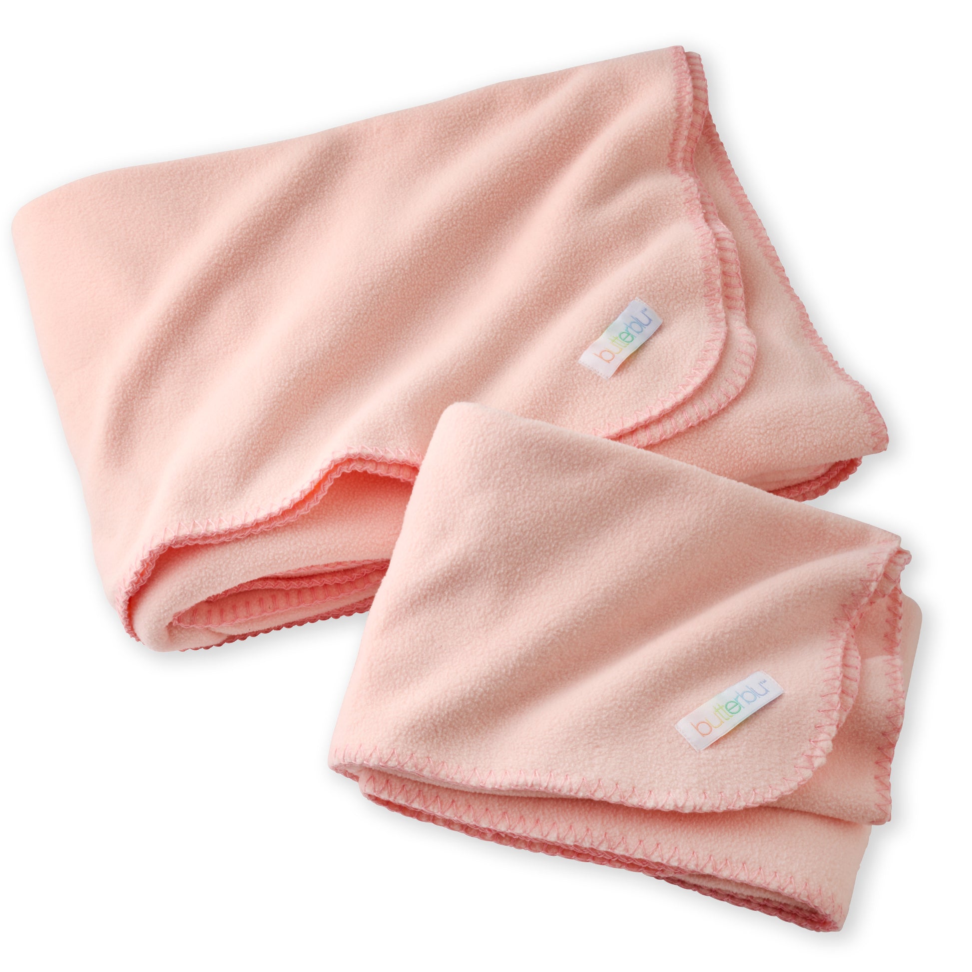 Folded pink baby blanket with a tag on a white background