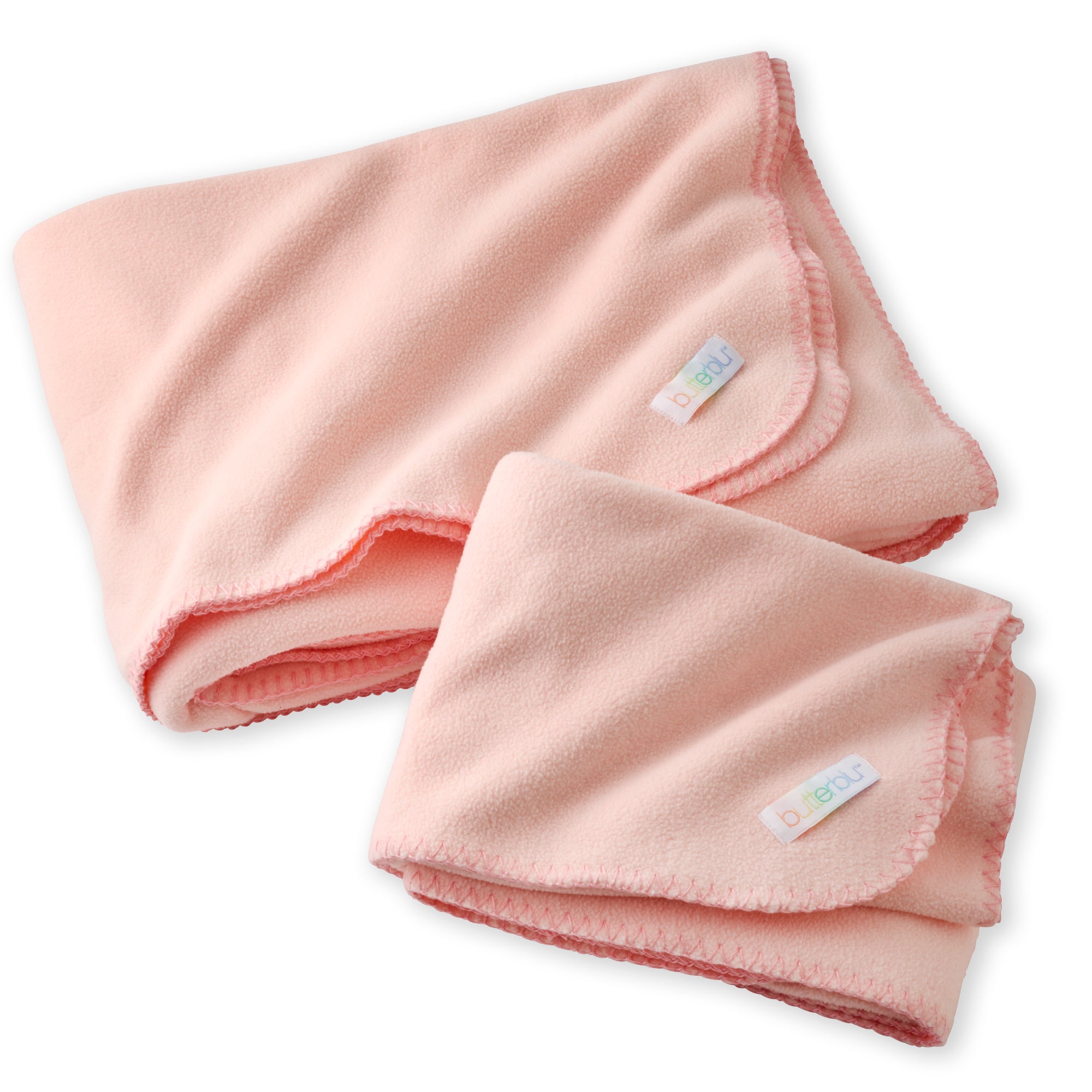Folded pink baby blanket with a tag on a white background