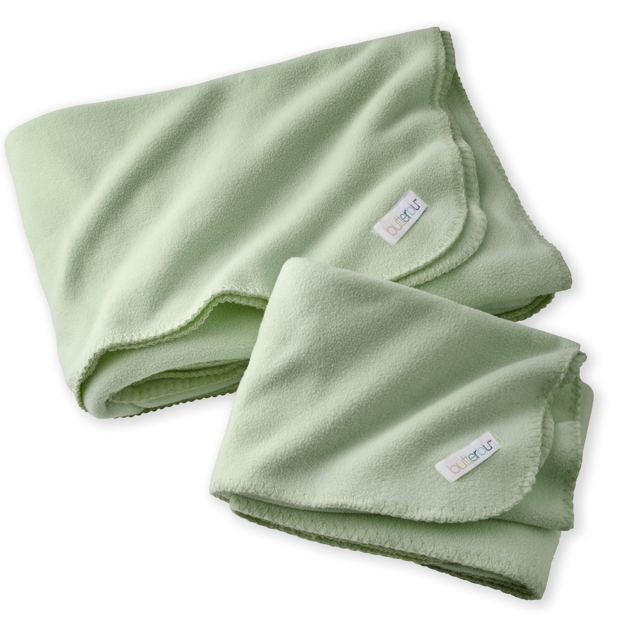 Folded green blanket with a brand label on a white background