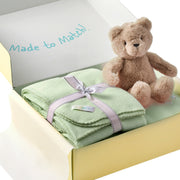 Green blanket with a teddy bear in a box labeled 'Made to Match'.