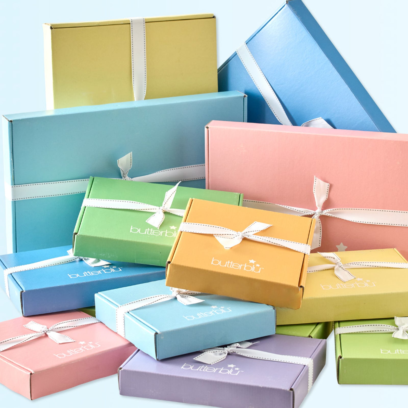 Colorful gift boxes with ribbons on a light blue background
