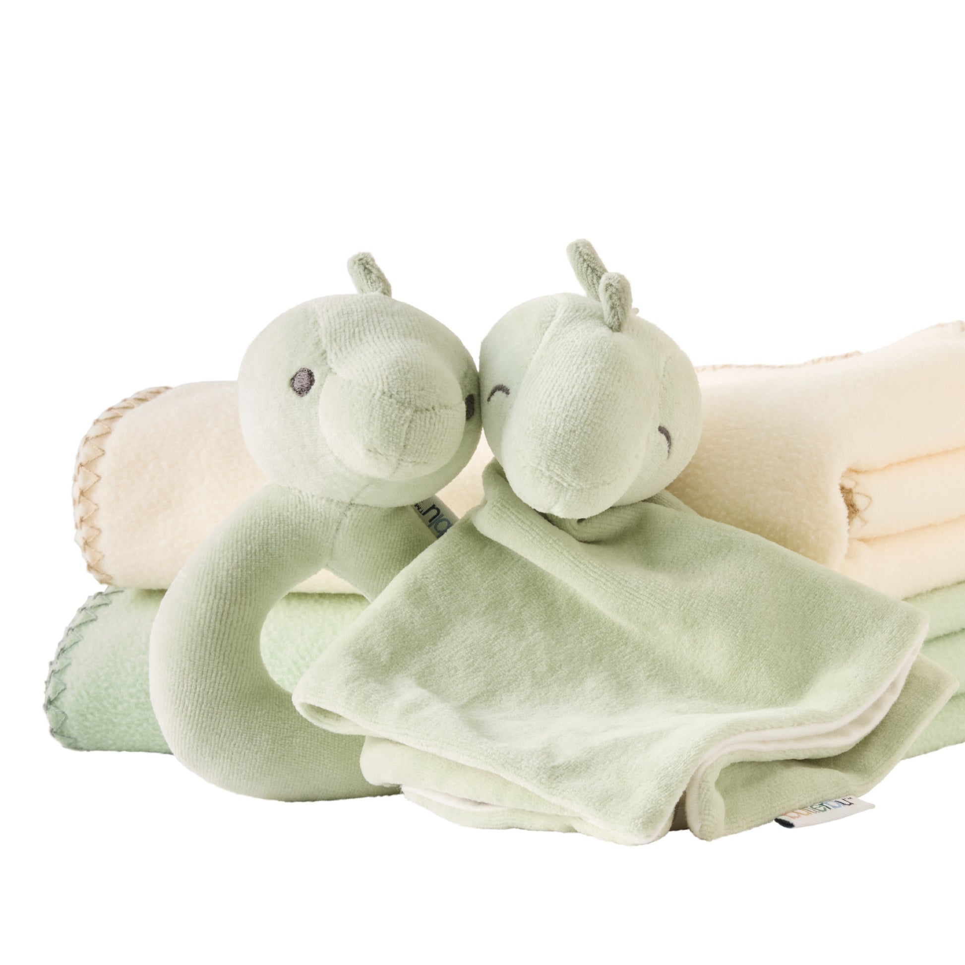 Two green plush toys with a blanket on a white background