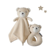 Two beige teddy bear toys with a blanket and rattle on a white background