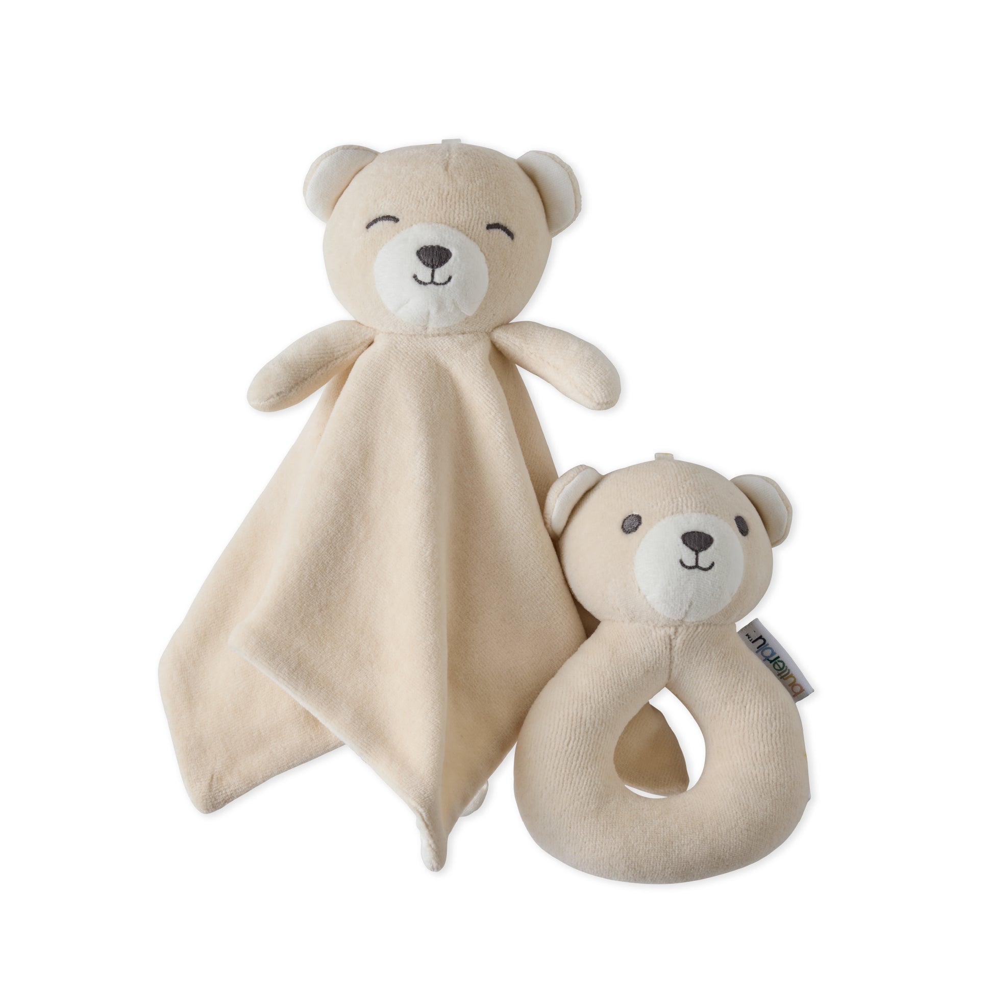 Two beige bear-shaped toys with a soft blanket and rattle on a white background