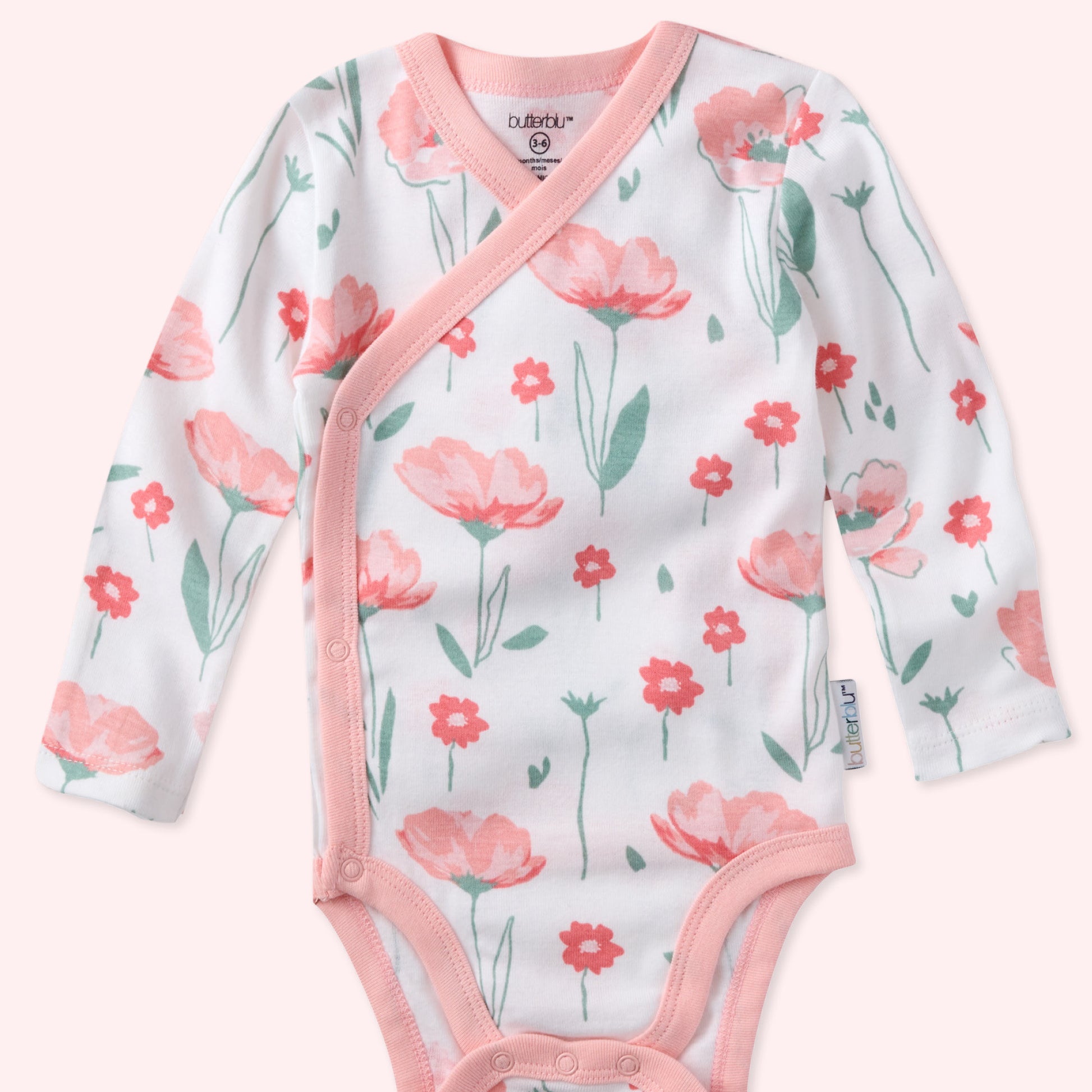 Floral-patterned baby onesie with pink accents on a white background