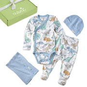 Baby clothing set with dinosaur pattern, including a onesie, pants, hat, and blanket, displayed in front of a green box with 'butterblu' branding.