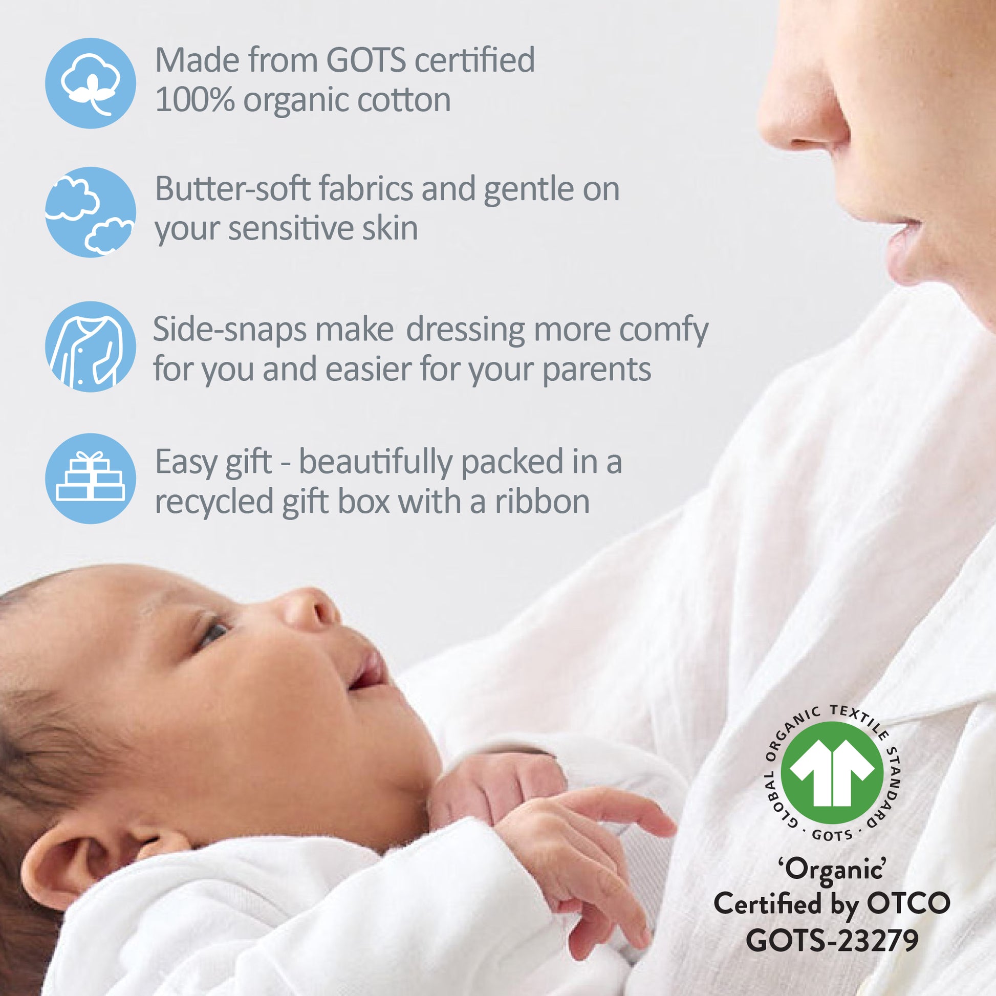Baby wrapped in organic cotton fabric with a mother, featuring GOTS certification details.
