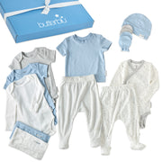 Collection of baby clothes including onesies, pants, and a hat with a 'butterblu' box in the background.