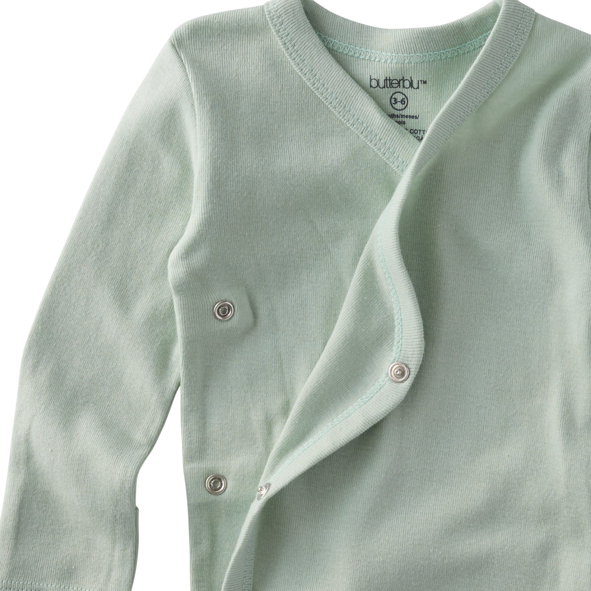 Light green baby cardigan with buttons on a white background