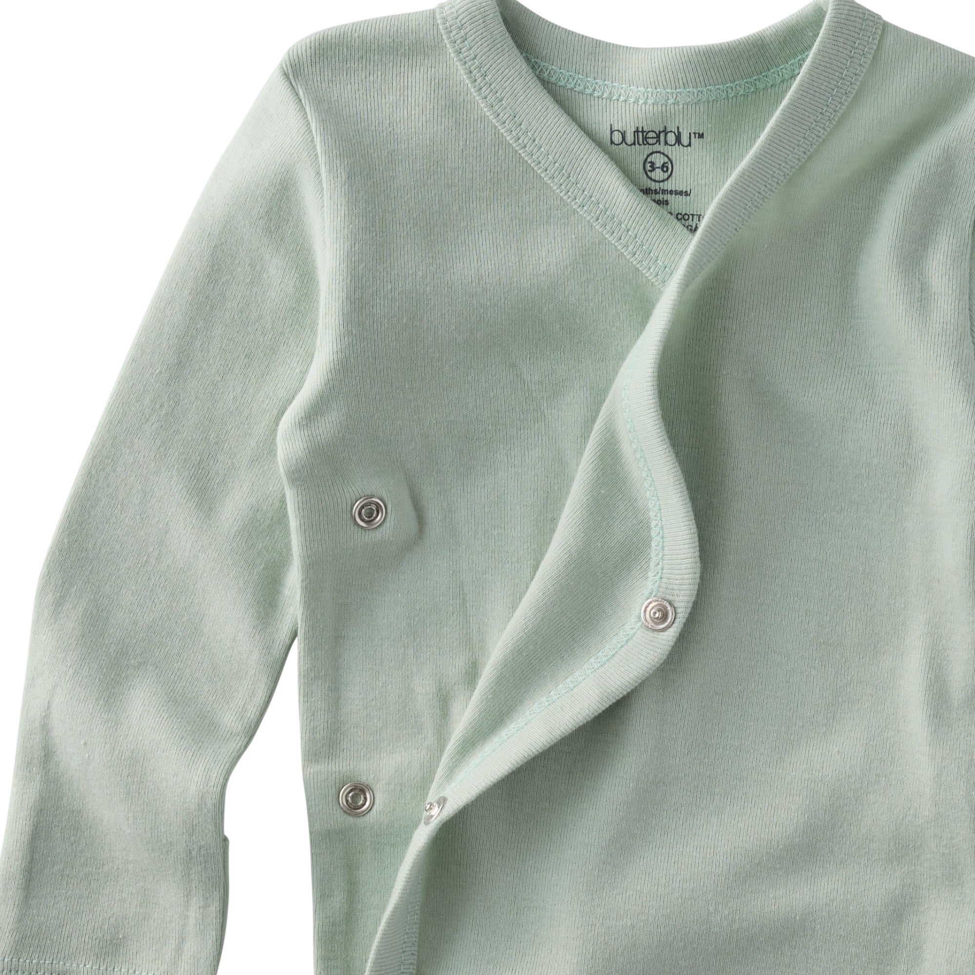 Light green baby cardigan with buttons on a white background