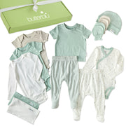 Collection of baby clothes including onesies, pants, and a hat with a 'butterblu' brand box.
