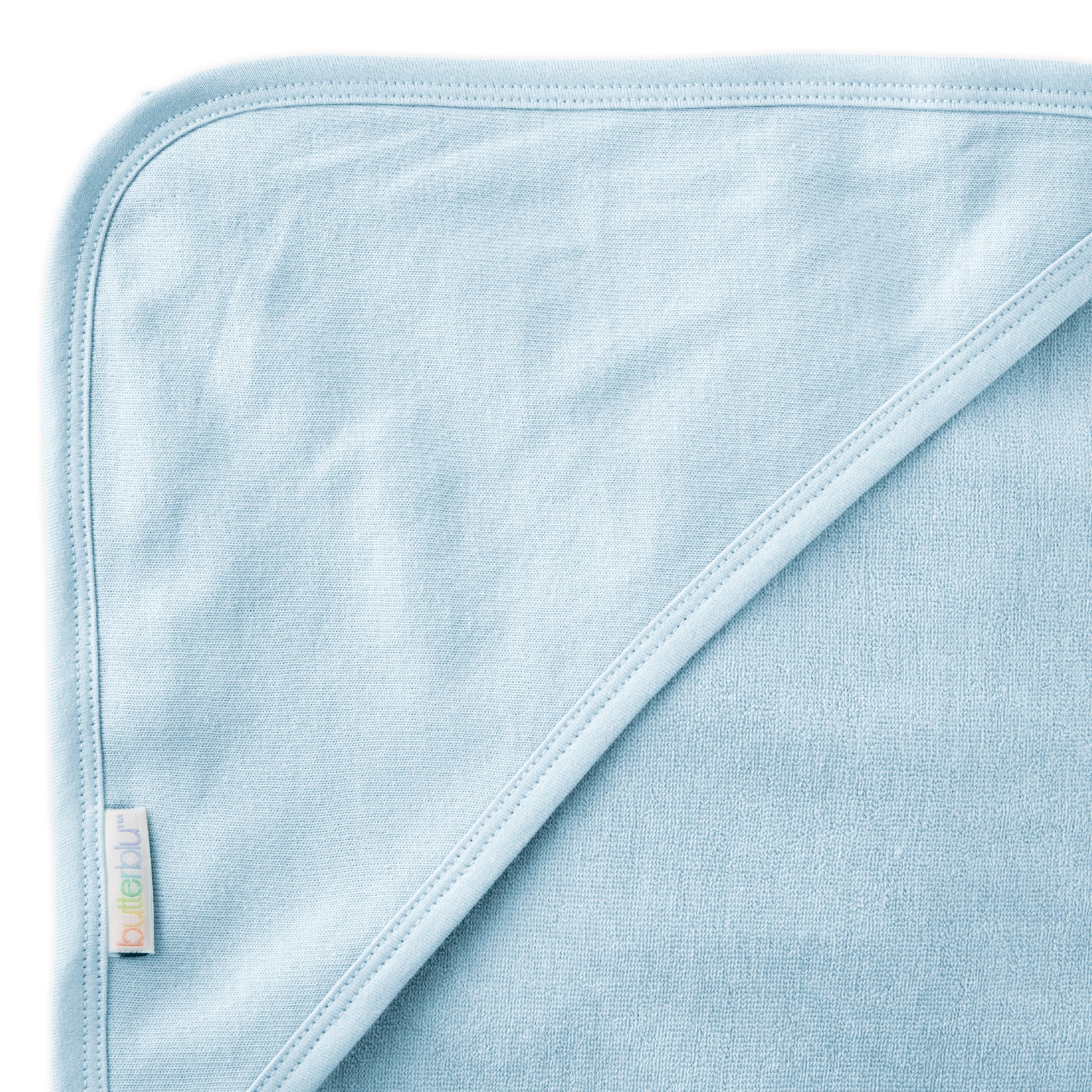 Close up of hood on towel with butterblu tag on towel