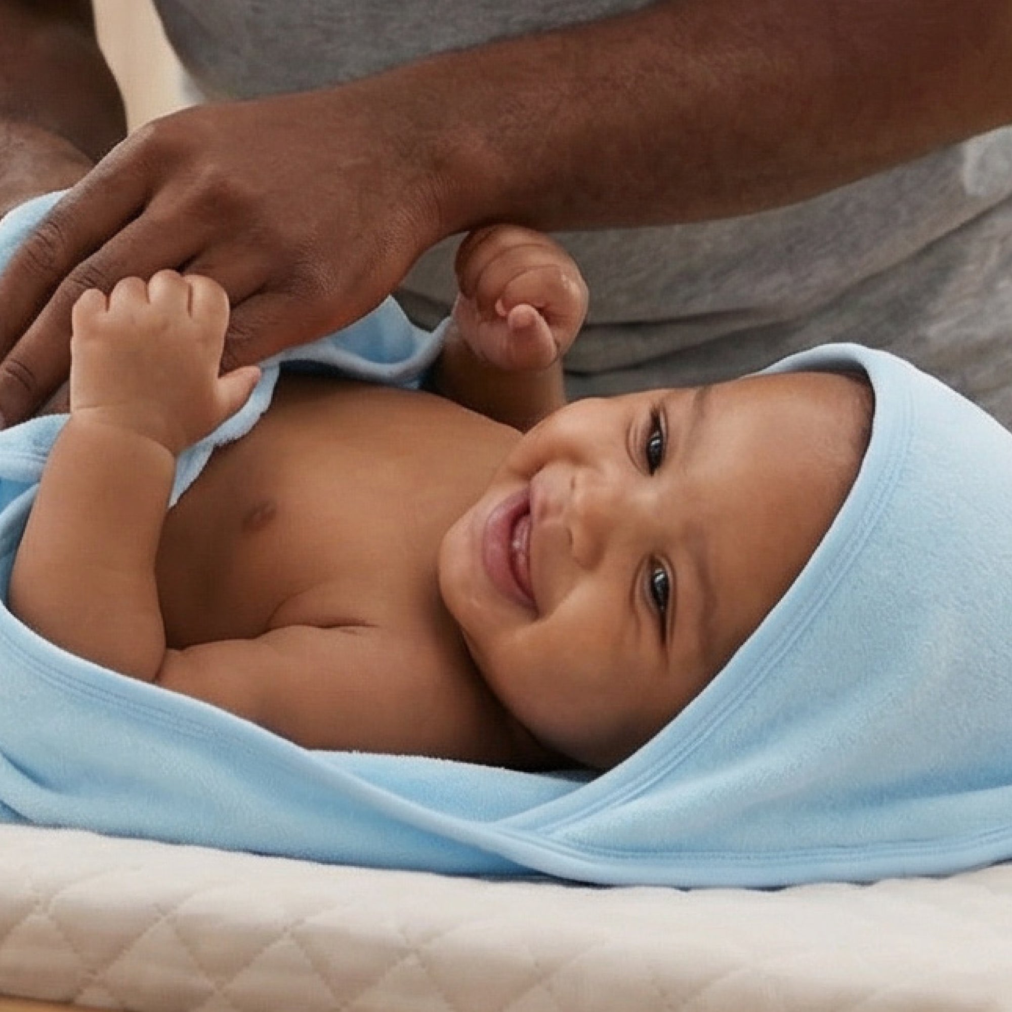 Baby wearing hooded towel