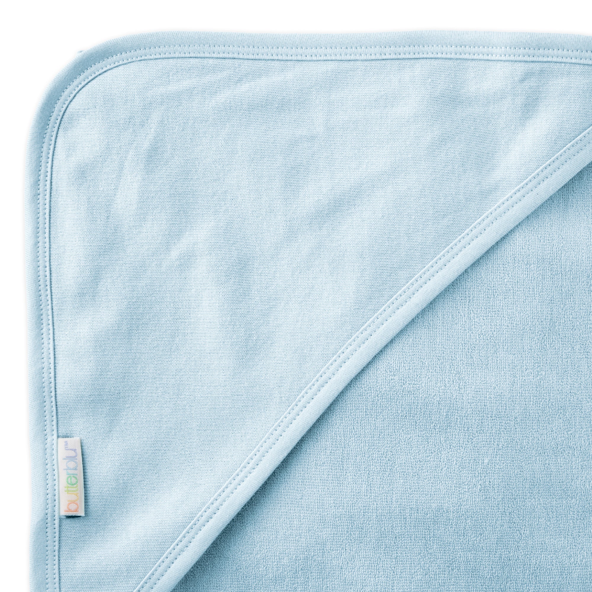 Close up of hood on towel with butterblu tag on towel