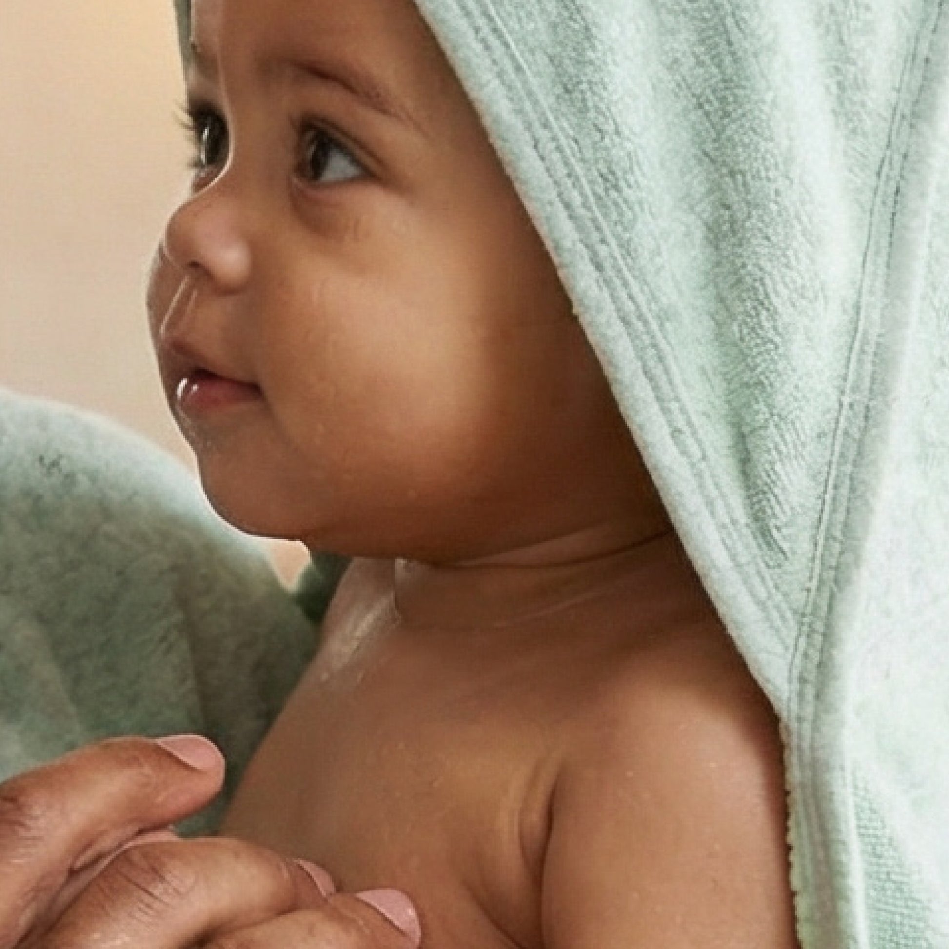 Baby wearing hooded towel