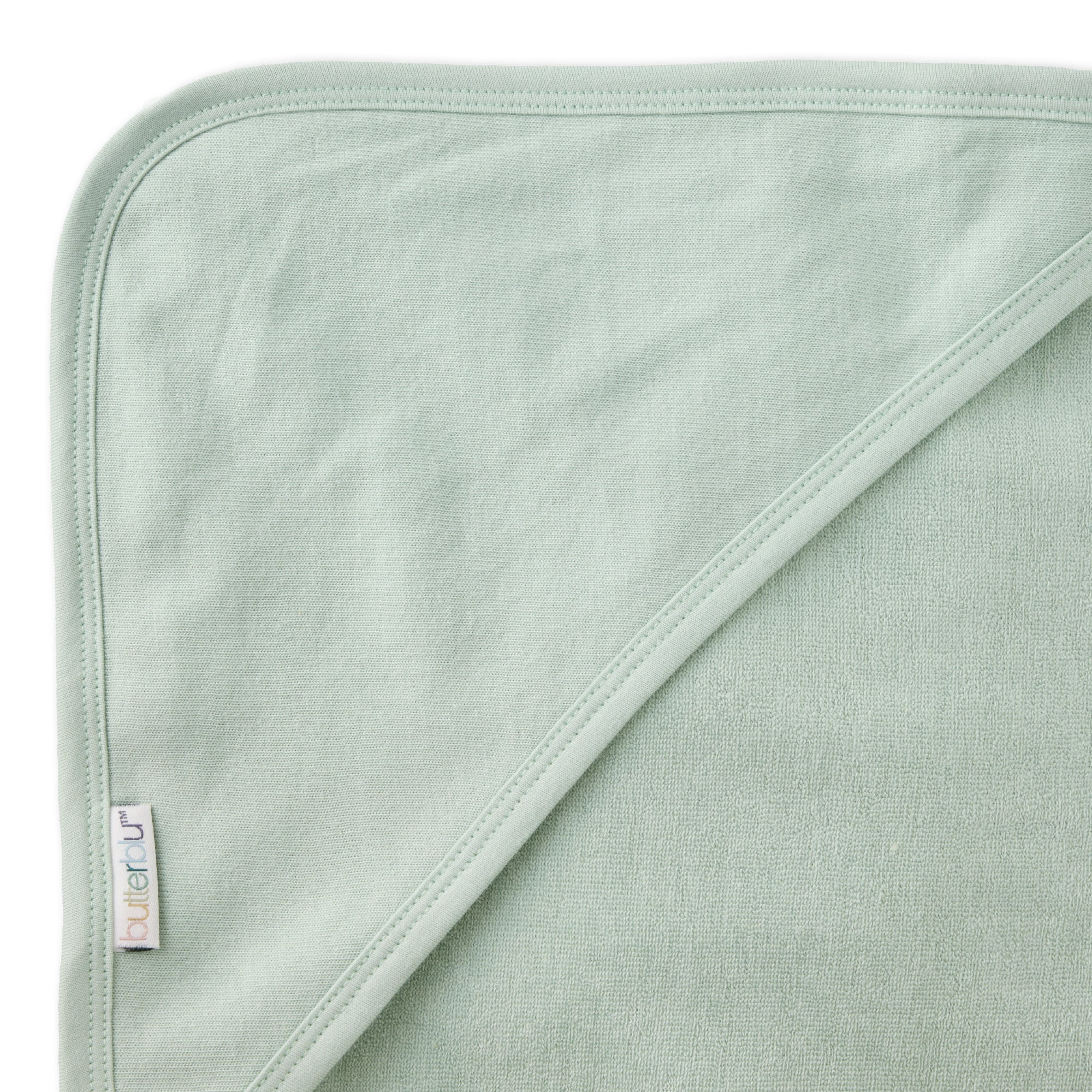 Close up of hood on towel with butterblu tag on towel