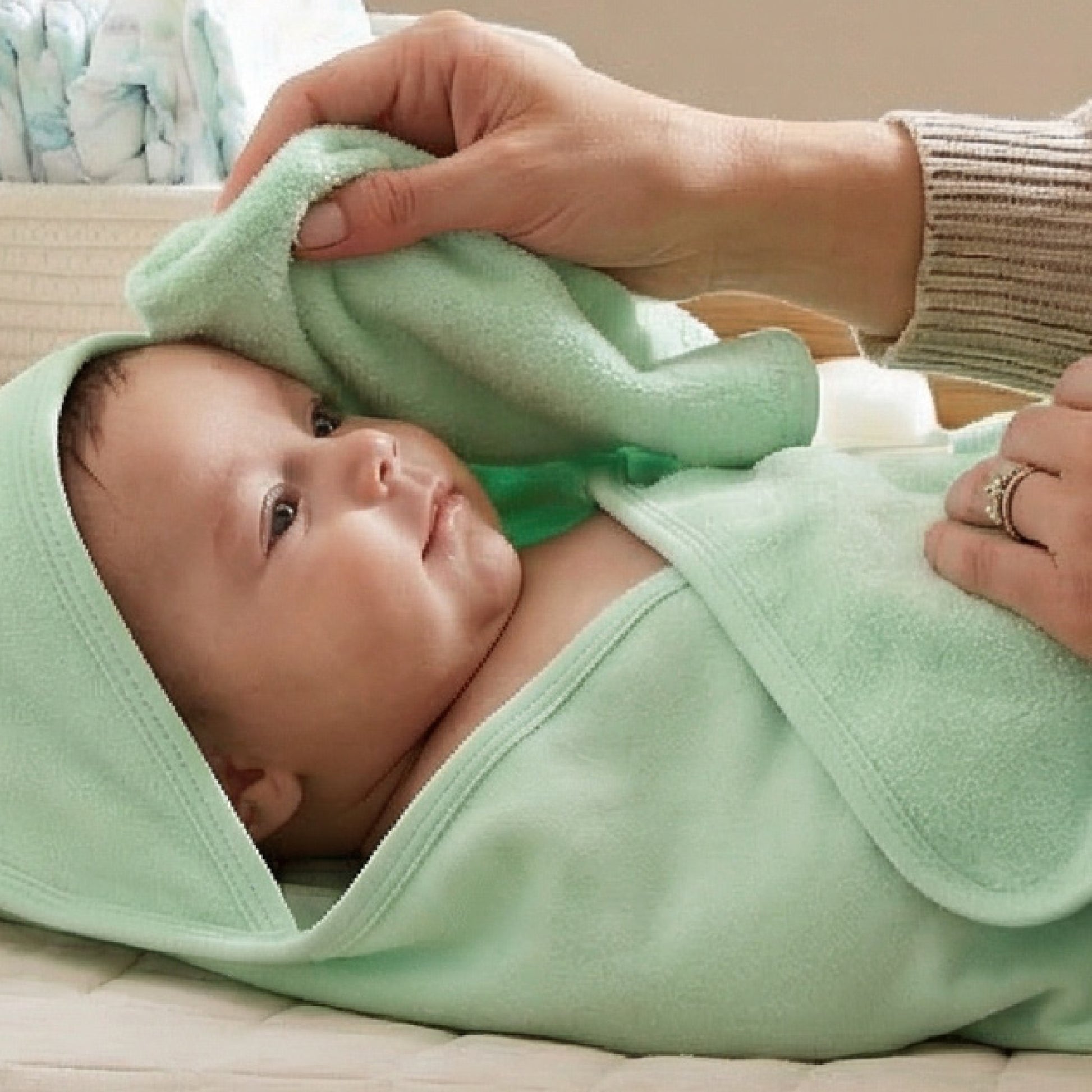 Baby wearing hooded towel