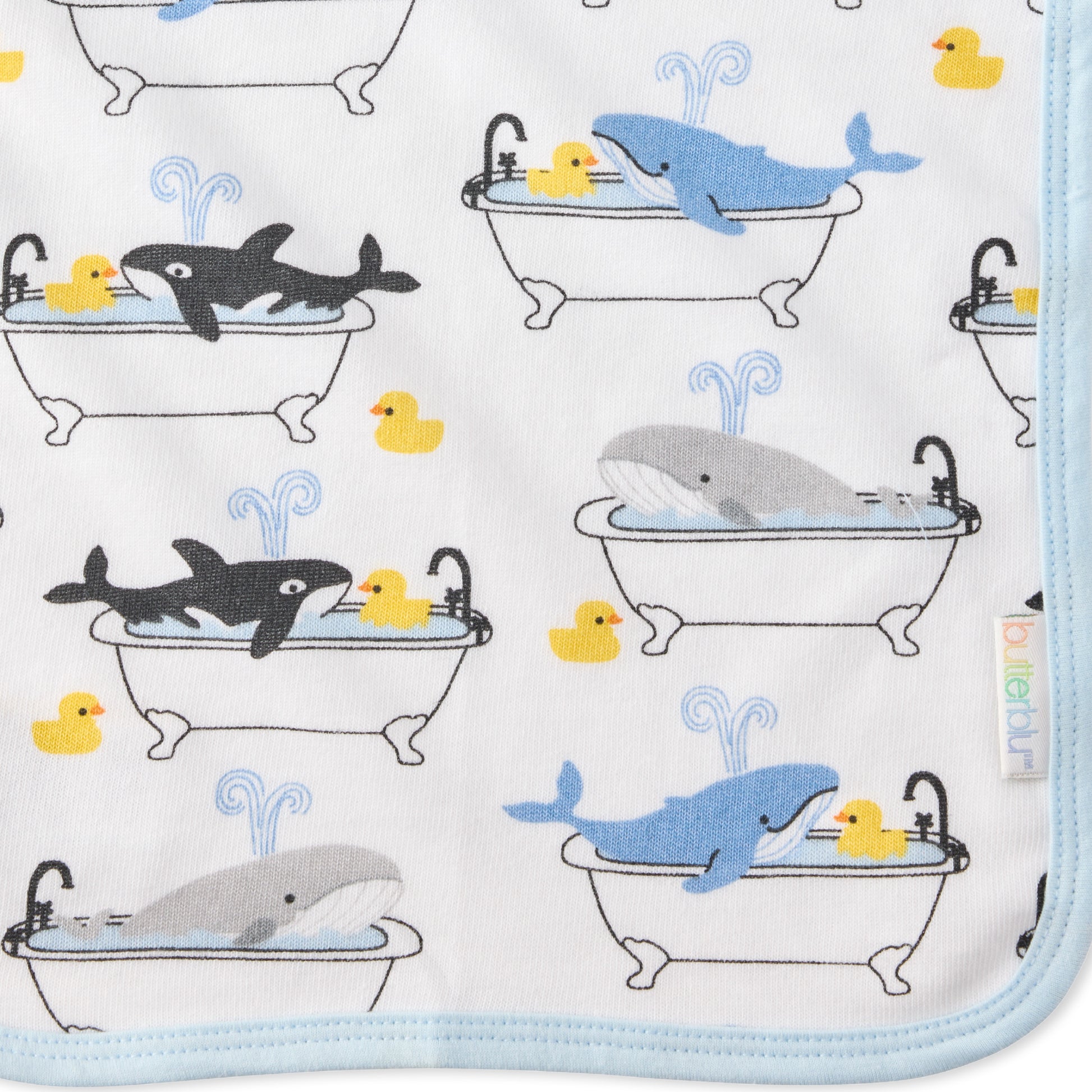 Close up of Oh Whale print on River washcloth and butterblu tag