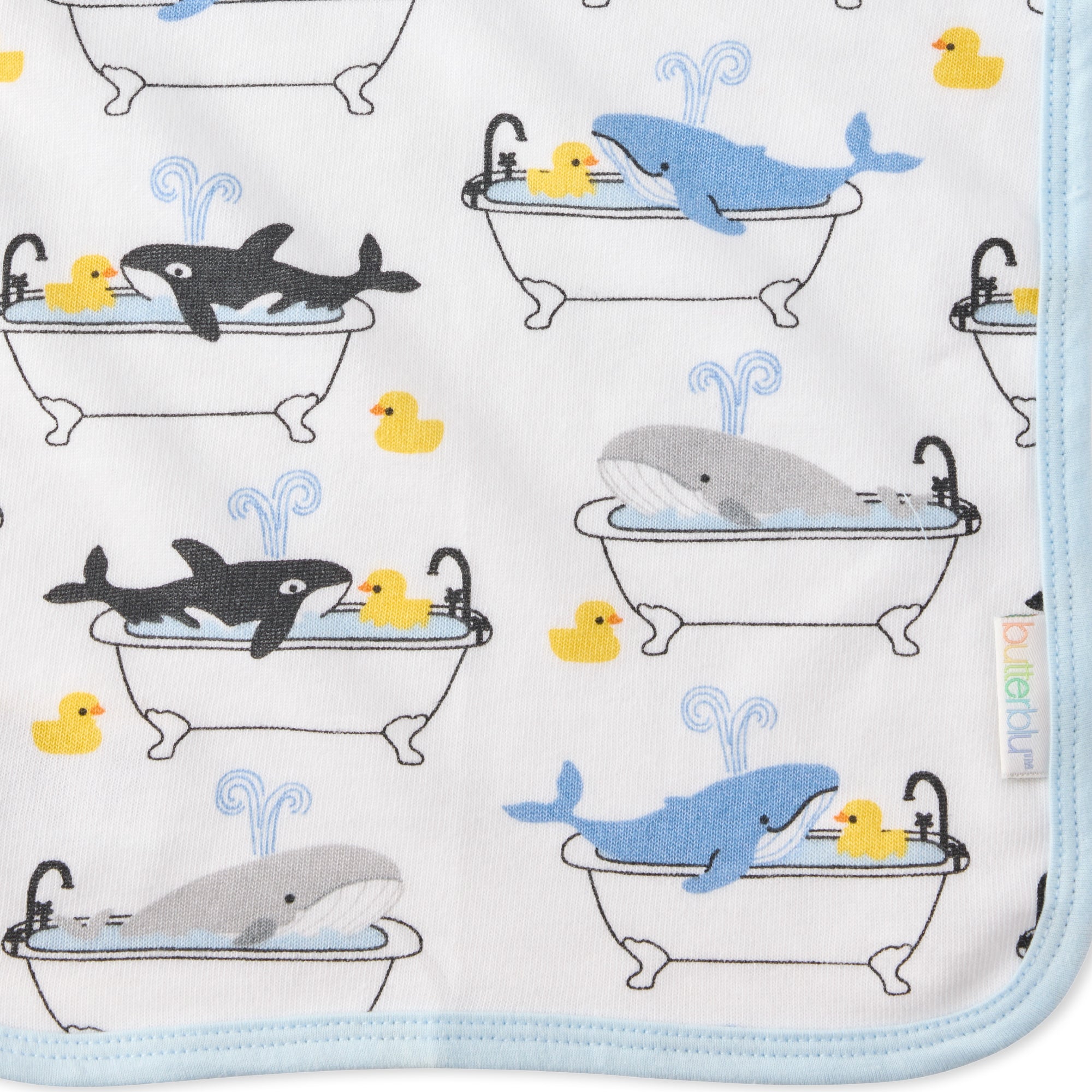 Close up of Oh Whale print on River washcloth and butterblu tag