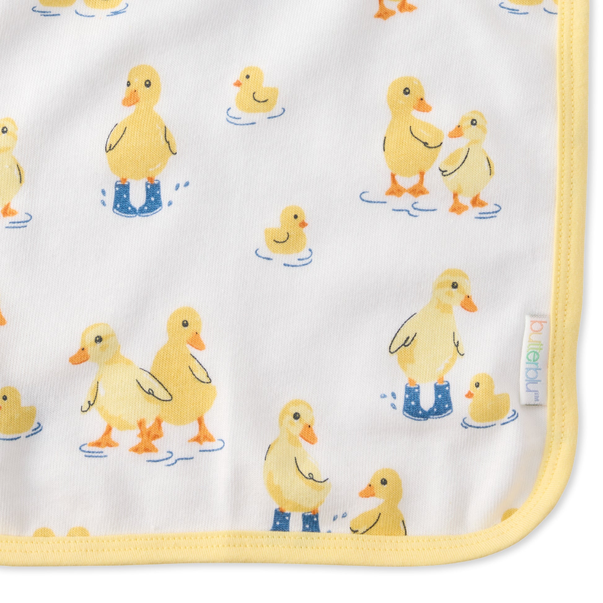 Close up of Puddle Jumpers print on River washcloth and butterblu tag