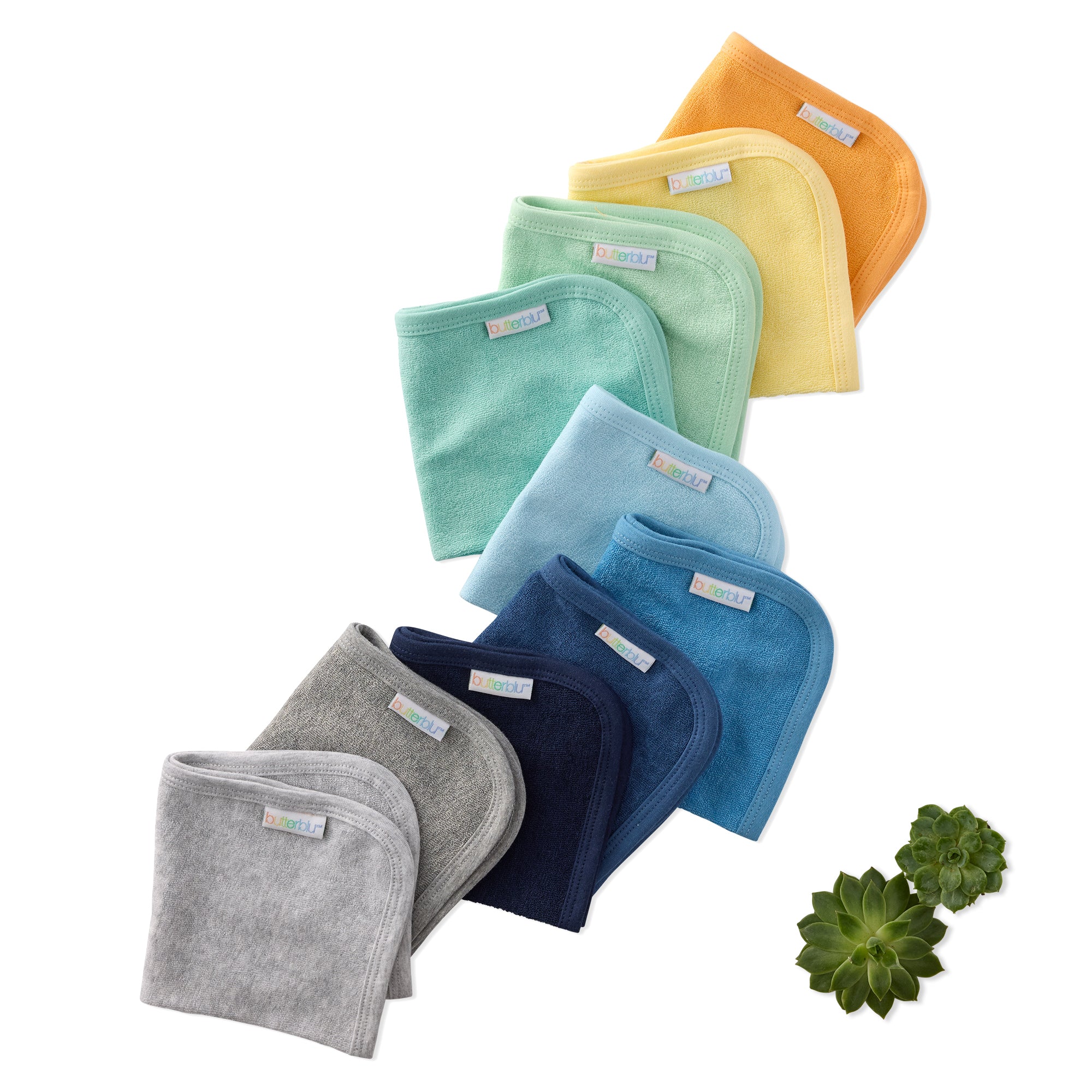 Set of colorful baby washcloths stacked on a white background with a succulent plant.