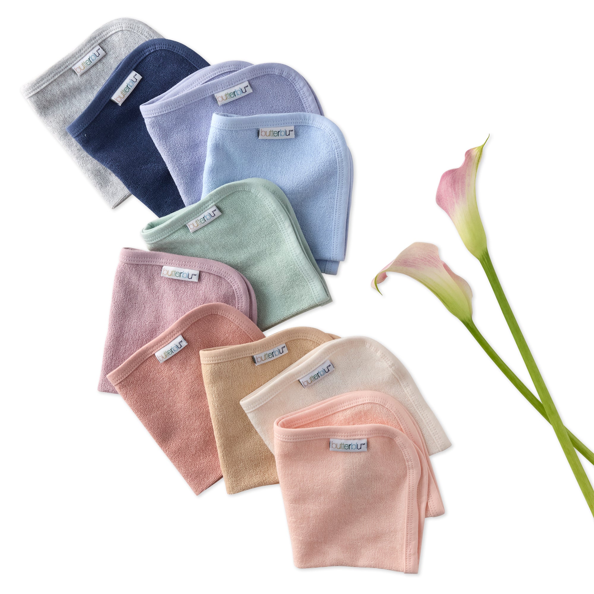 Set of folded baby washcloths in various colors with a flower on a white background
