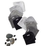 Set of washcloths on a white background with stones.