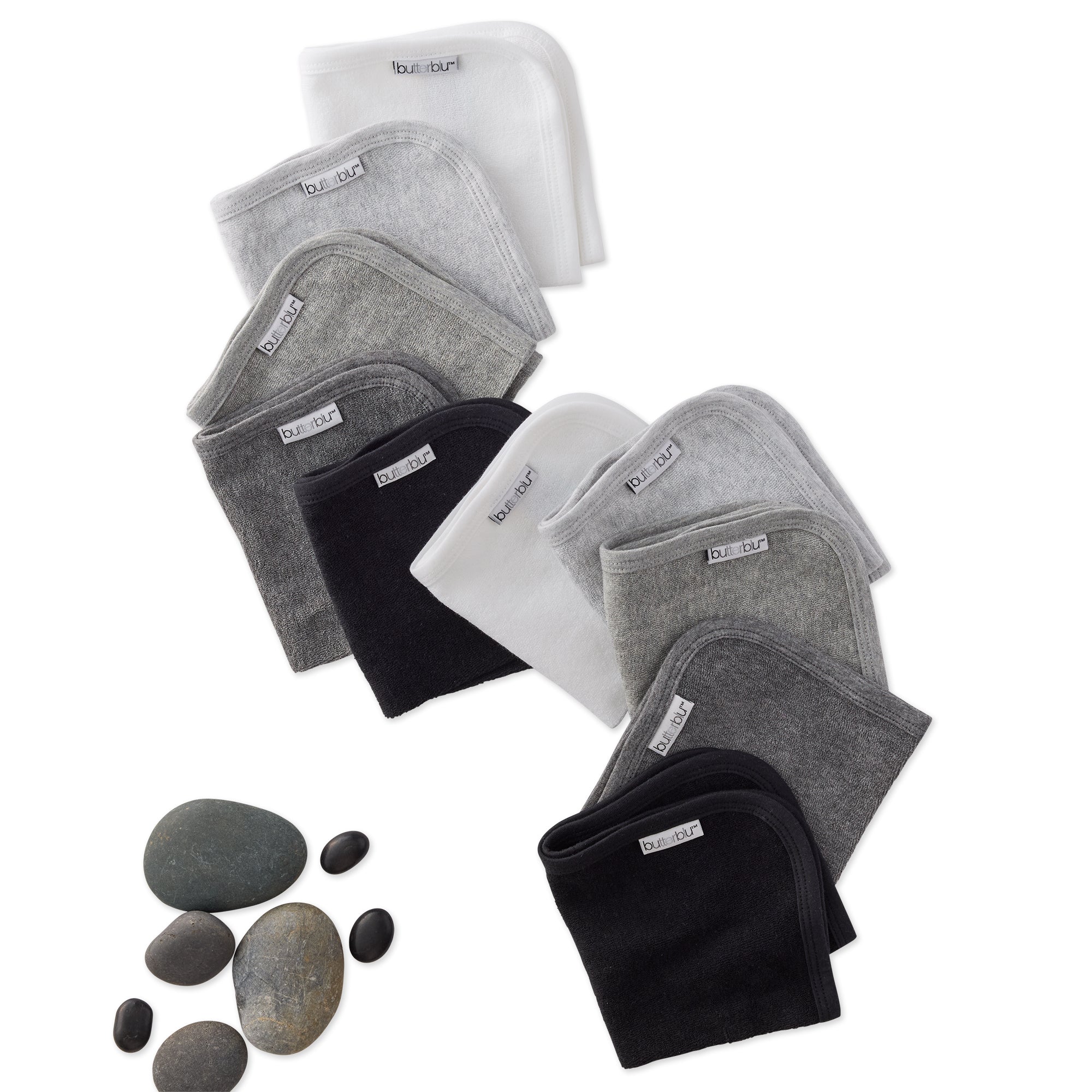 Set of washcloths on a white background with stones.