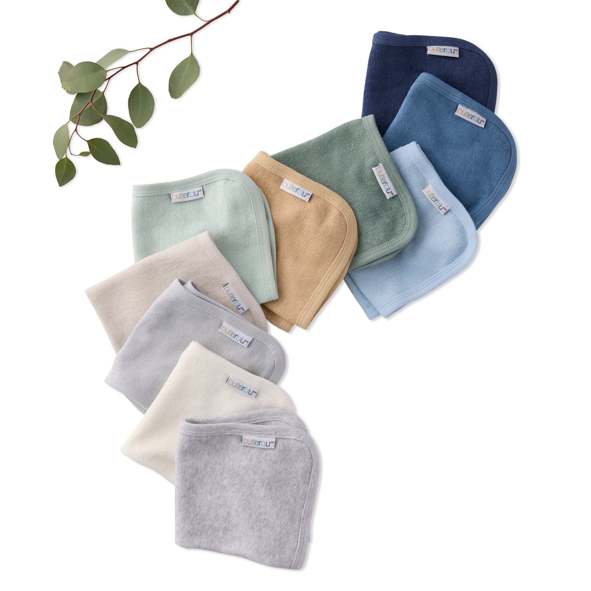 Set of colorful baby washcloths on a white background with a branch and leaves.