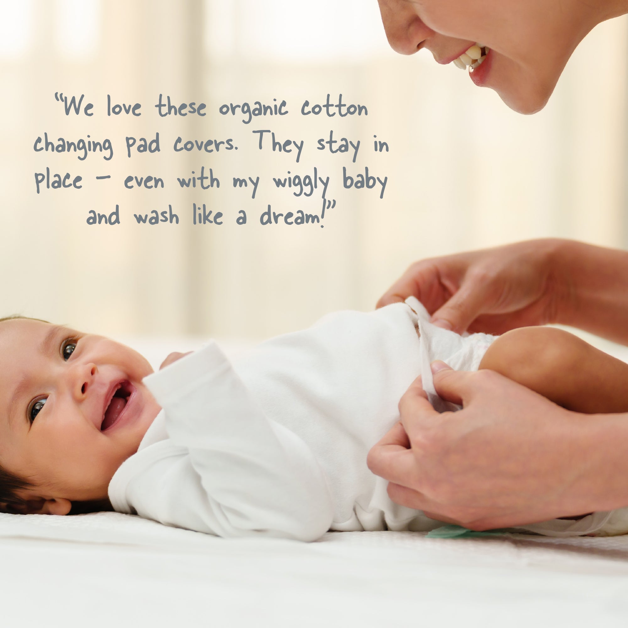 Baby being changed by a person with text about organic cotton changing pad covers.
